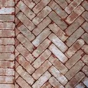 Close-up of a recycled brick paving installation in Melbourne arranged in a herringbone pattern.