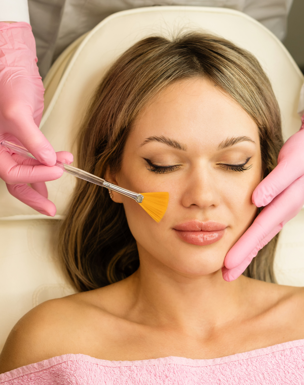 Client receiving a professional skin treatment with a treatment mask application.