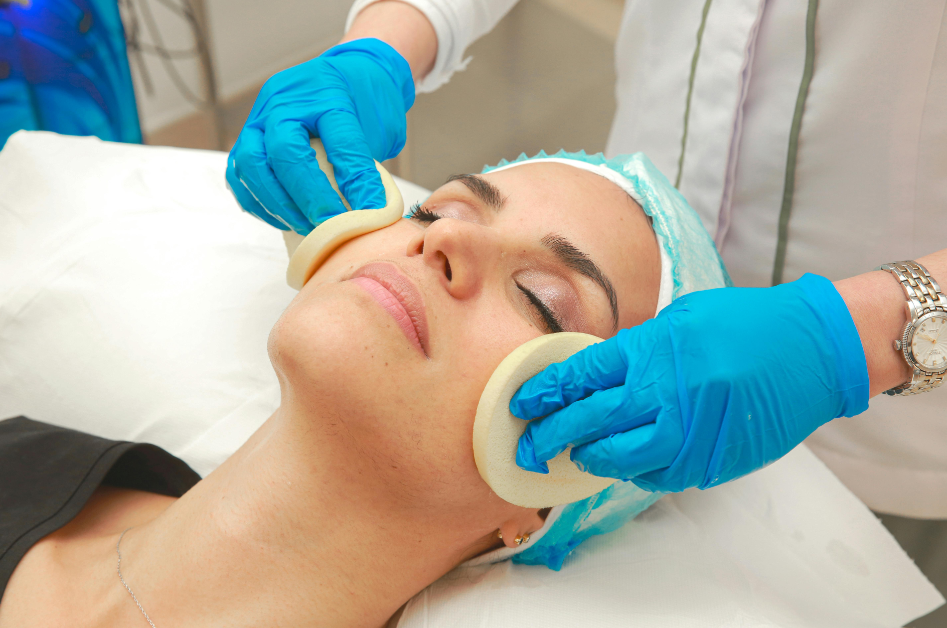 Client receiving a professional skin treatment in a clinic setting.
