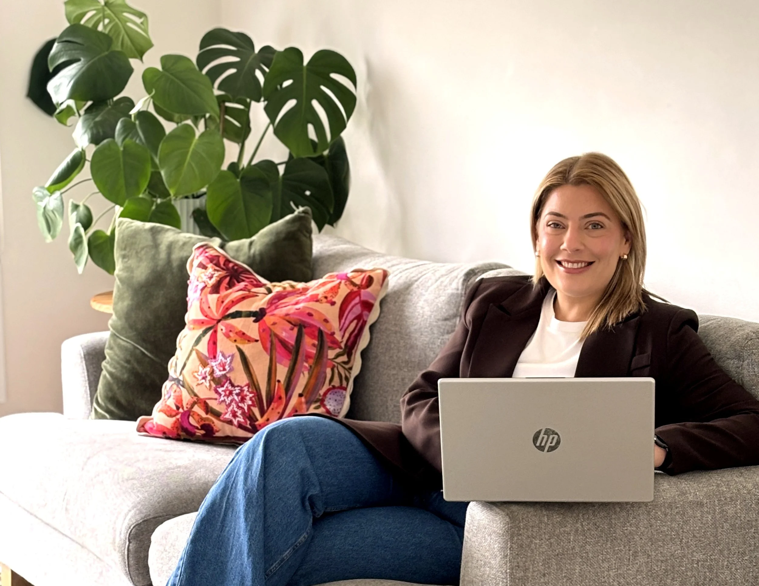 Girl sitting on couch with laptop