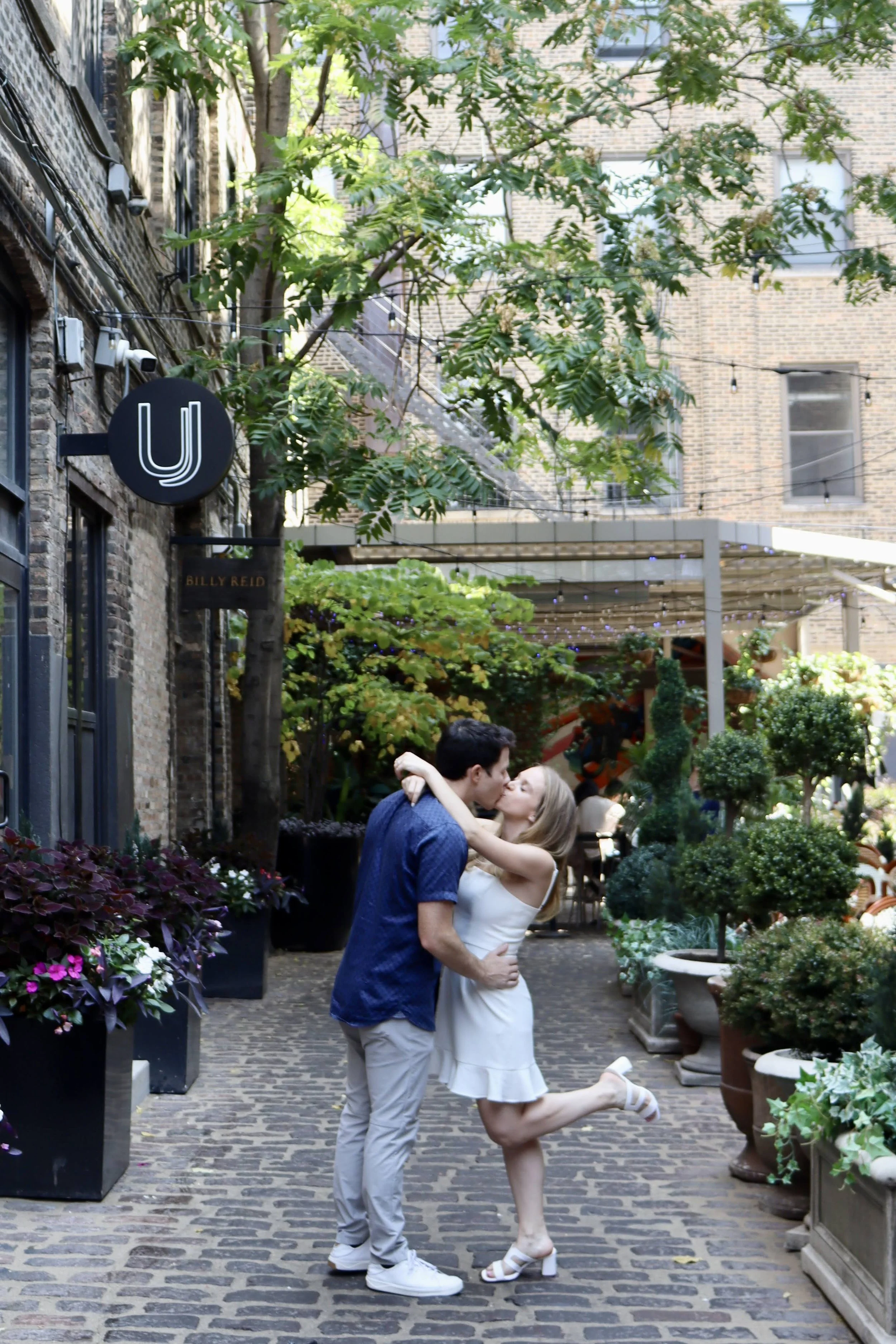 Jojo Rubnitz Photography Engagement brick road leg up kissing coupleJPG.JPG