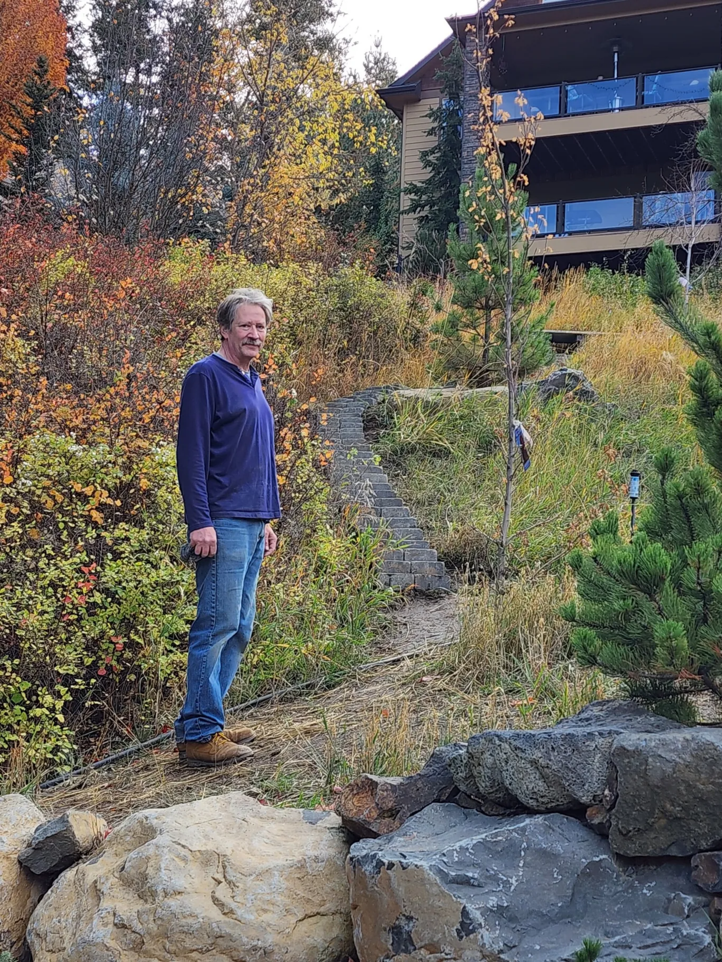 Mike, the handy man, standing next to a flagstone path he installed outside