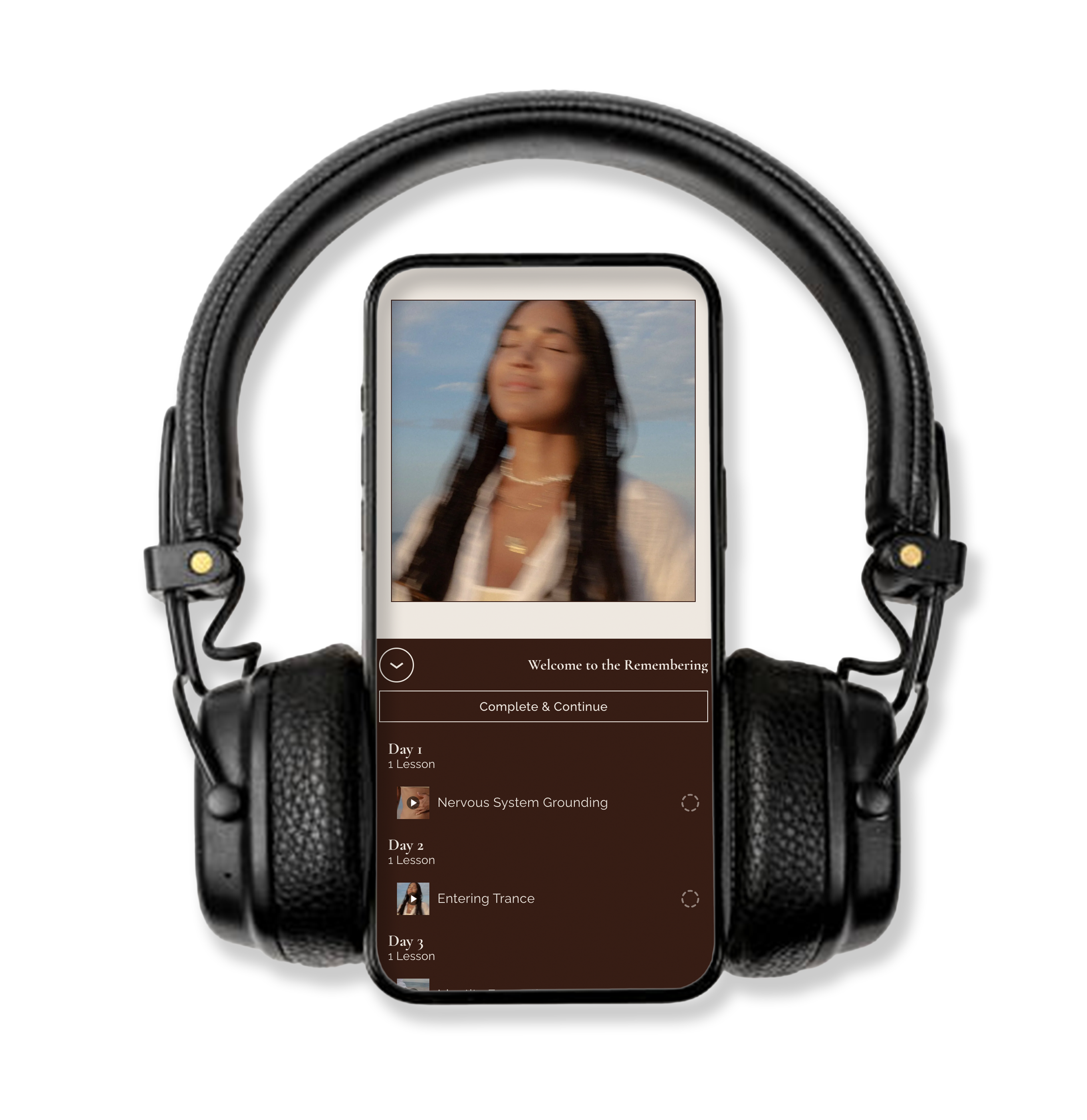 A smartphone mounted with headphones displays a meditation or mindfulness app with a woman with long dark hair, eyes closed, and a serene expression against a blue sky background.