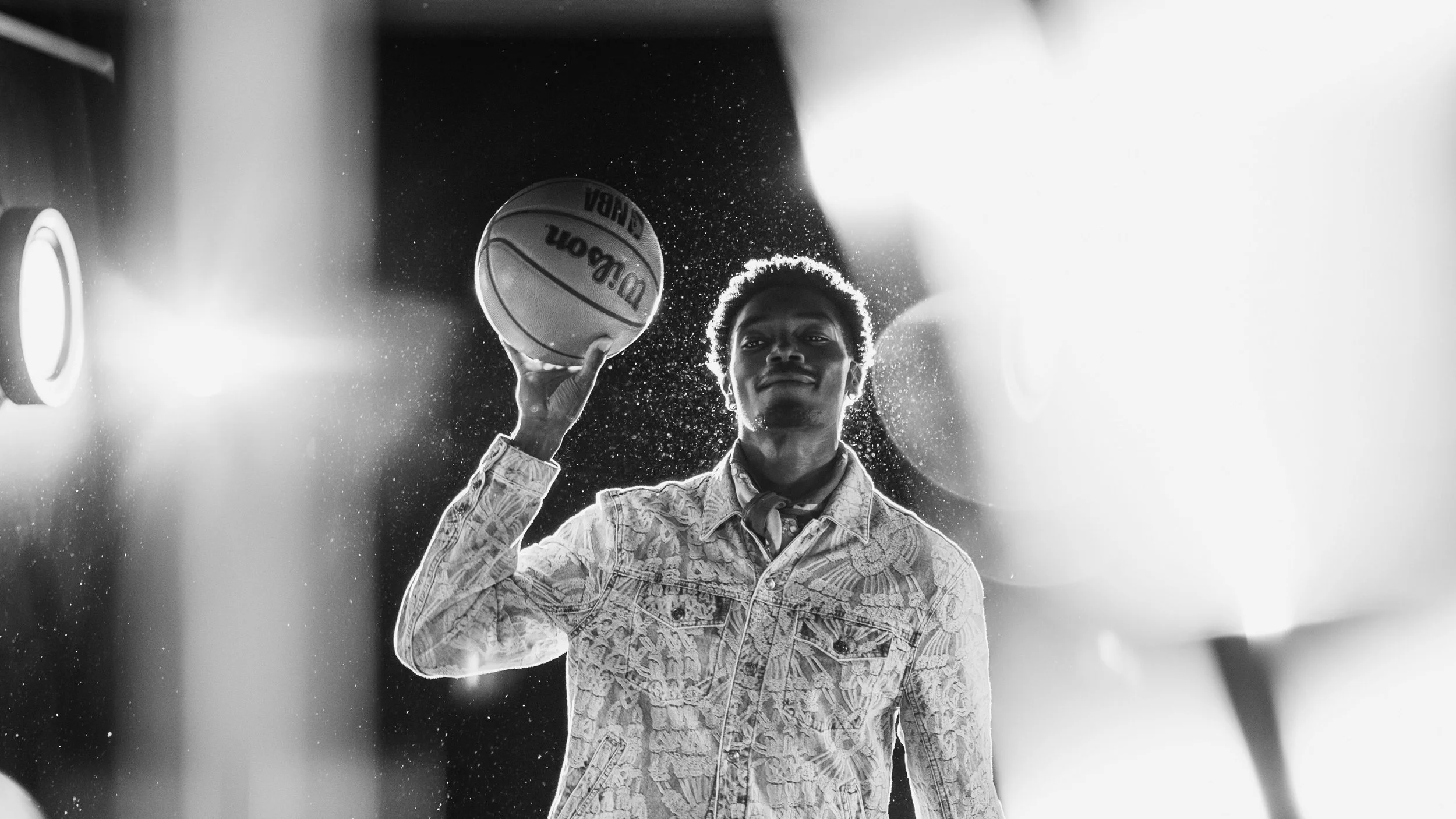TOBi holding a basketball posing for a photo in studio.