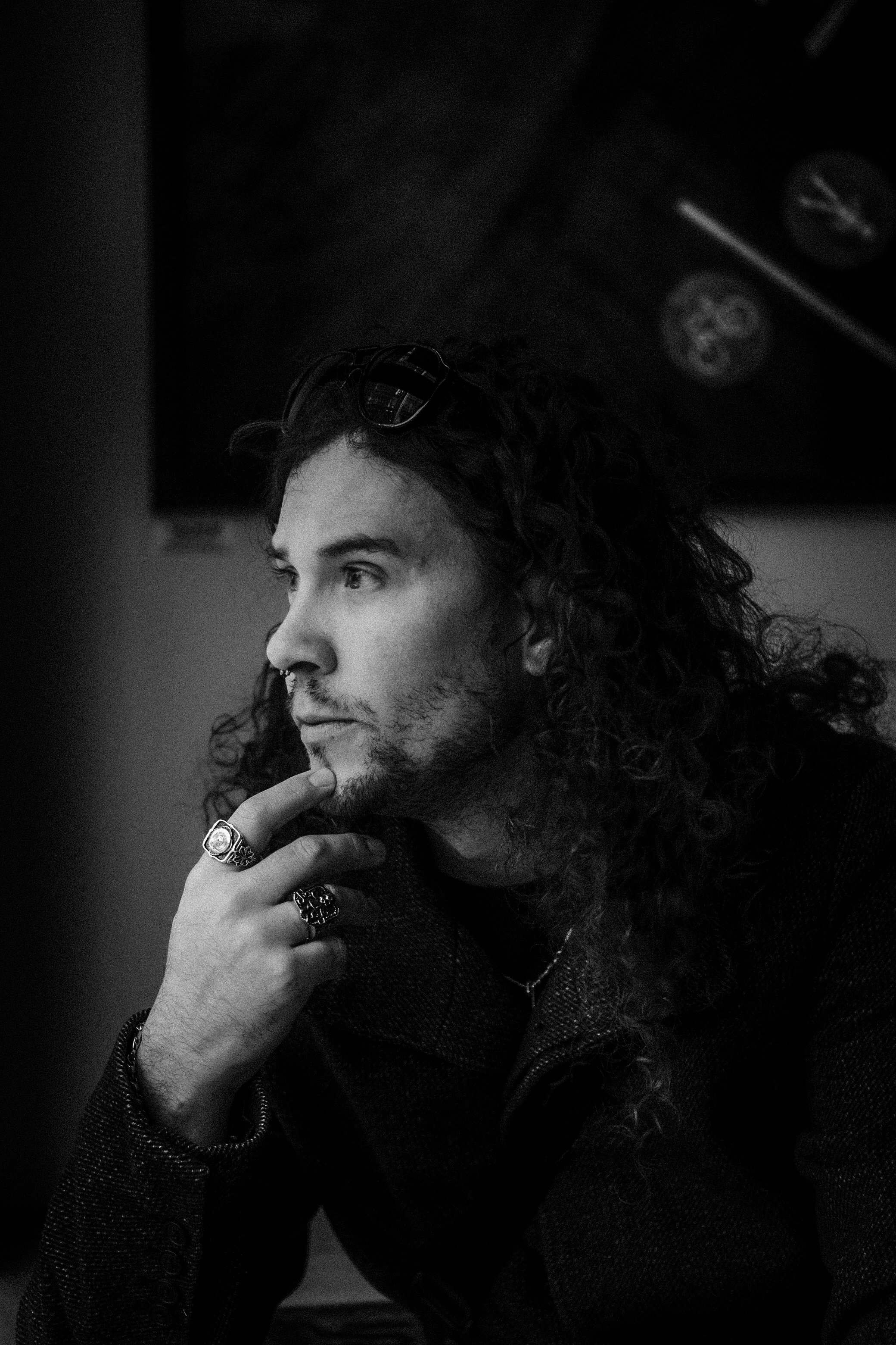 Kris Lamb posing for a photo with his hand on his chin looking off to the left.