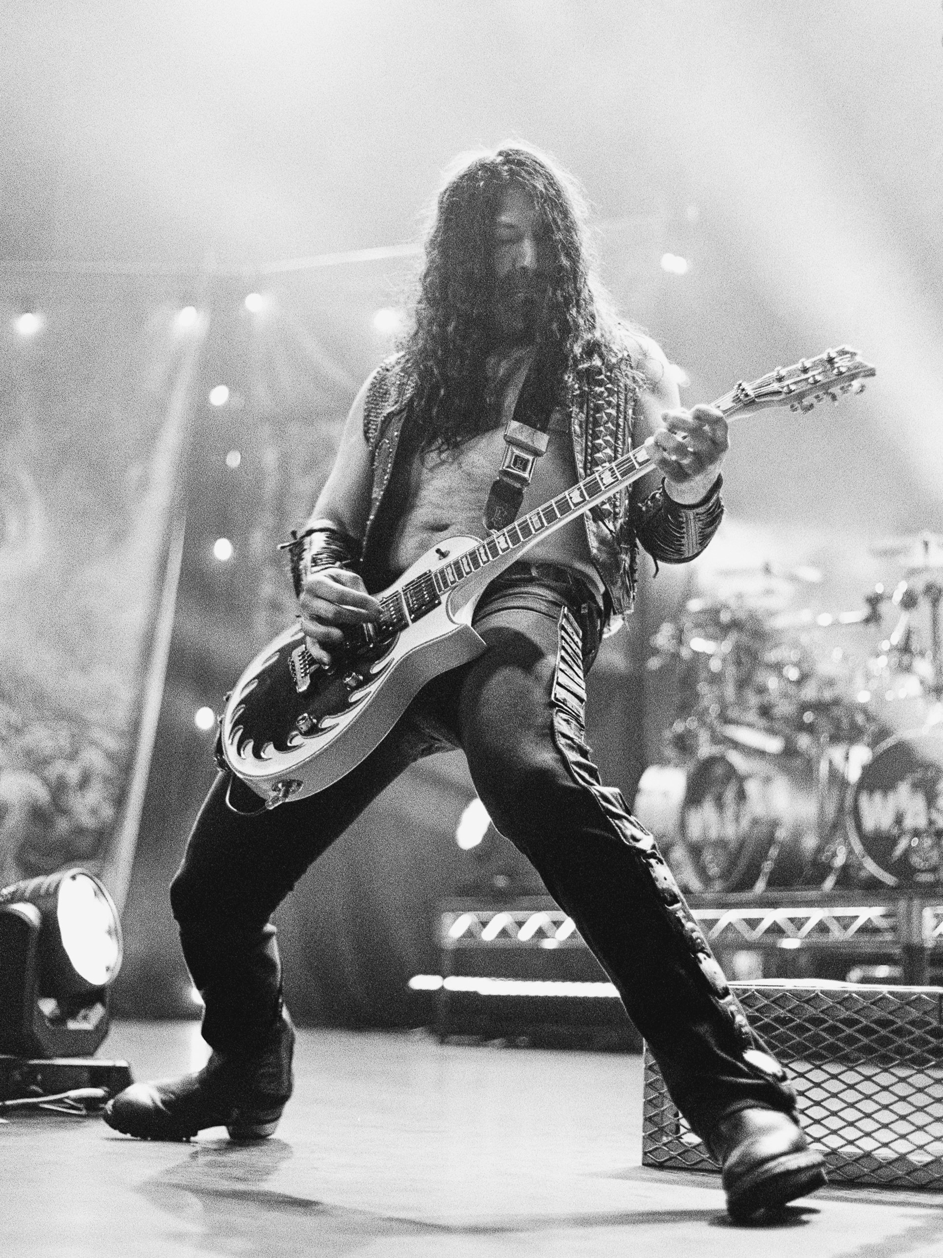 Doug Blair of W.A.S.P. playing guitar on stage.