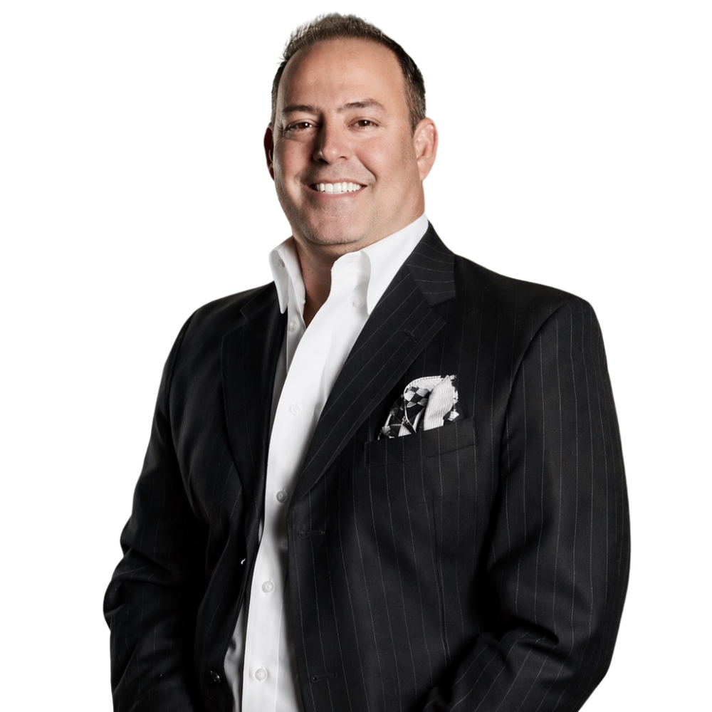 A man in a black pinstripe suit and white shirt, smiling, facing slightly to the right.