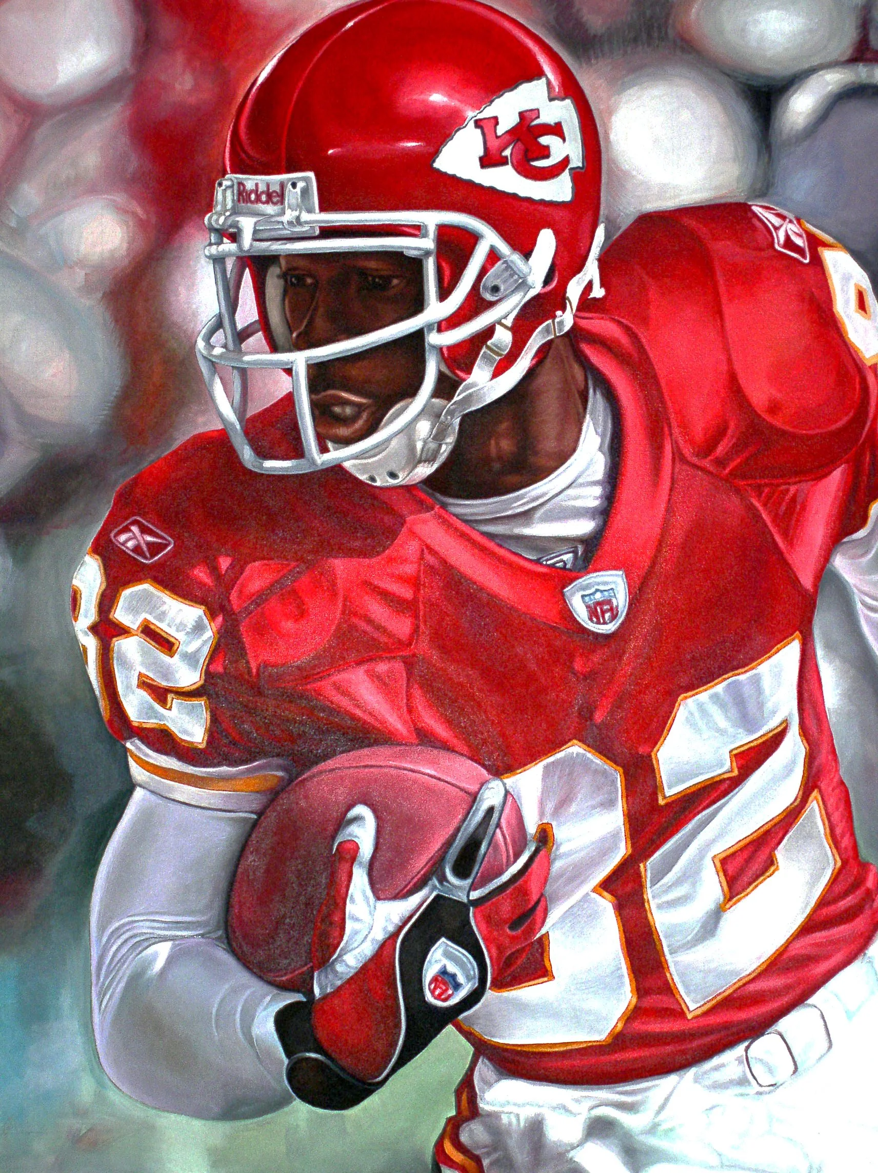 A football player in a red Kansas City Chiefs uniform holding a football, wearing a helmet with the team logo, running on the field.