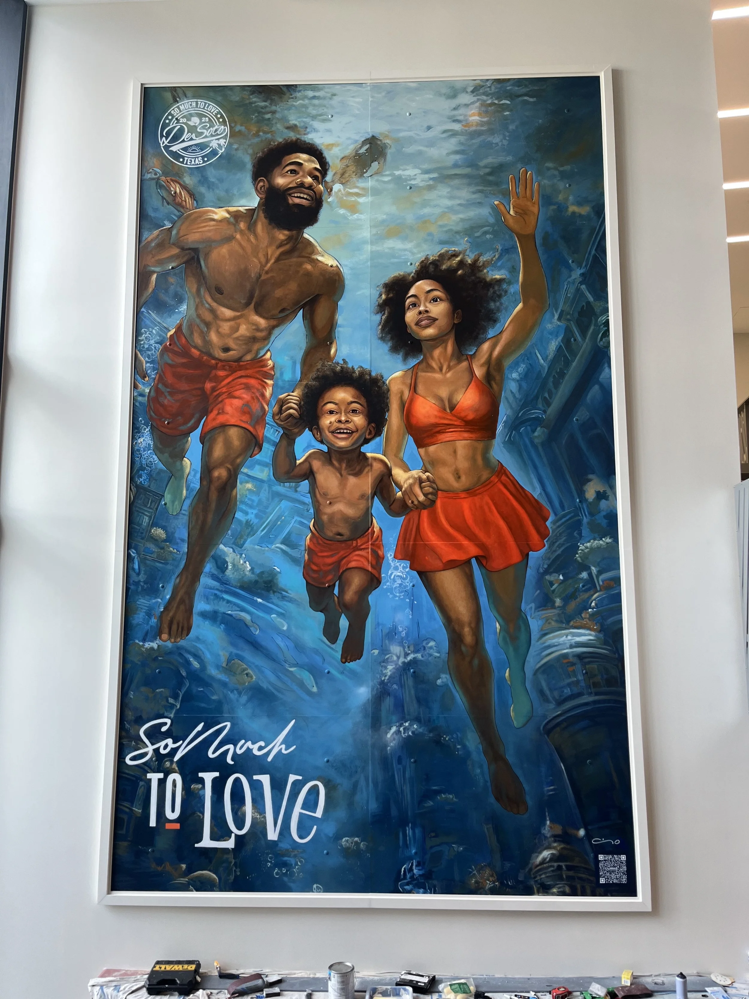A colorful mural of a happy family swimming underwater, with the text 'So Much to Love' in the bottom left corner.