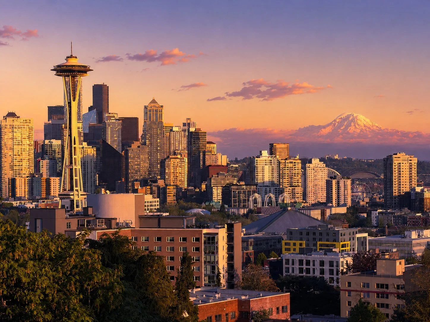 Seattle skyline at sunset with the Space Needle in the foreground and Mount Rainier on the horizon
