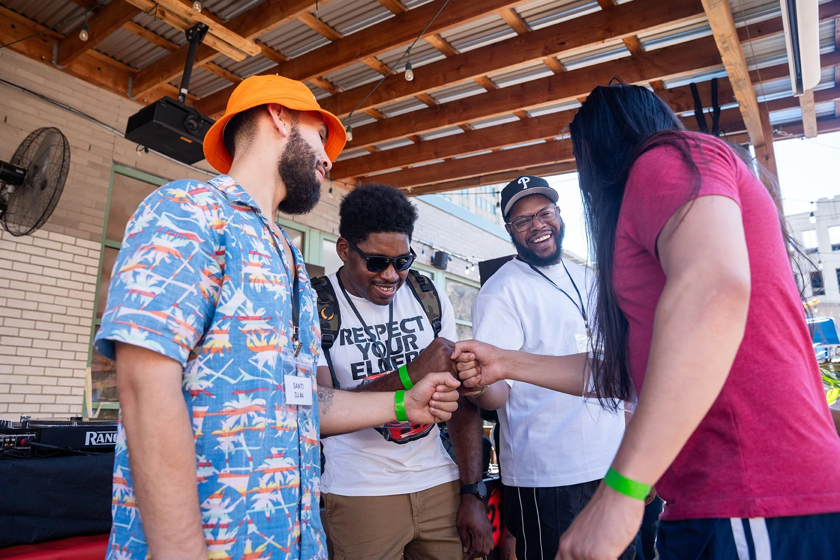 Santi, DJ Proud, DJ Don Will, and YNGFU huddling together and laughing at Liberty Point