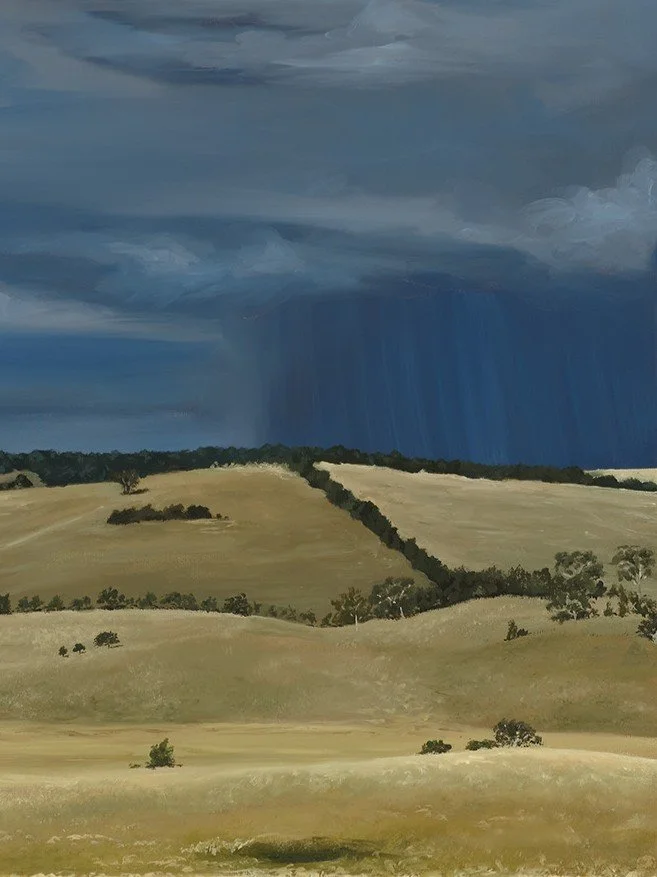 Close up of a fine art print of a dry grassy farm landscape with looming storm clouds to show brushwork and texture