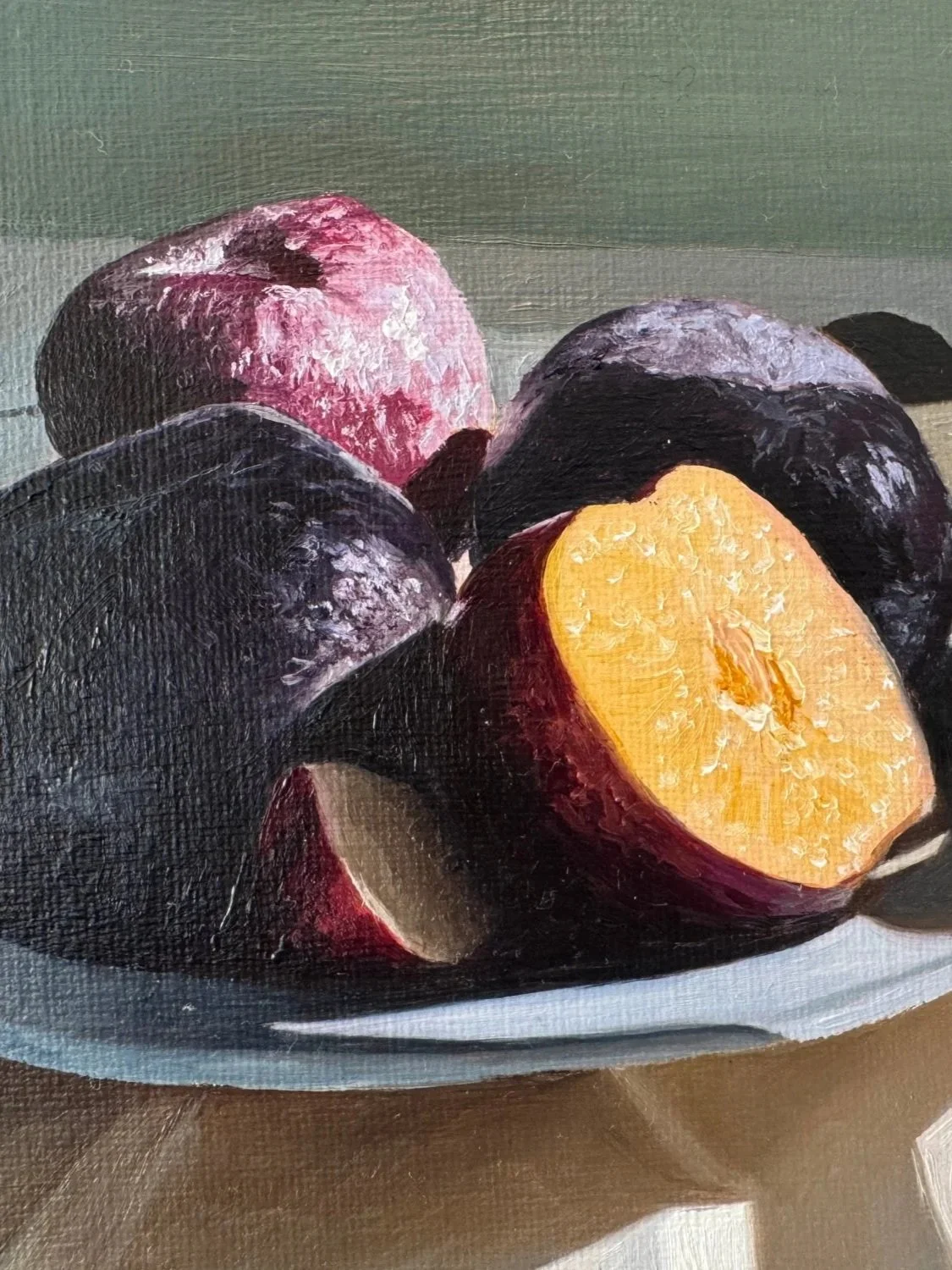 Close up of still life oil painting of plums showing brushwork and texture