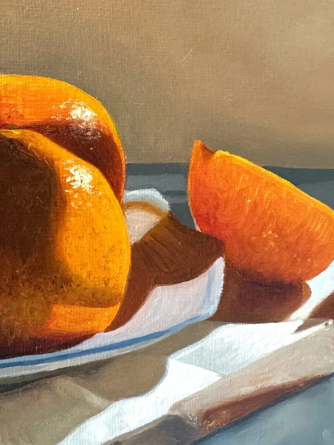 Close up of still life oil painting of oranges showing brushwork and texture