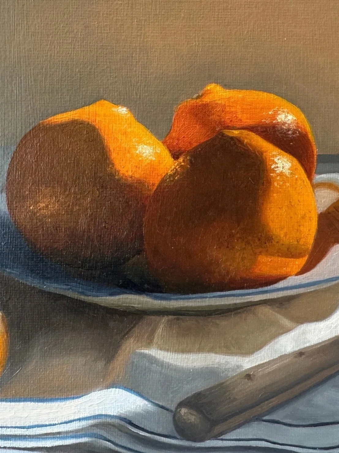 Close up of still life oil painting of oranges showing brushwork and texture