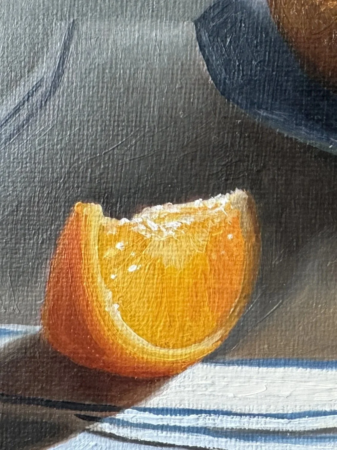 Close up of still life oil painting of oranges showing brushwork and texture