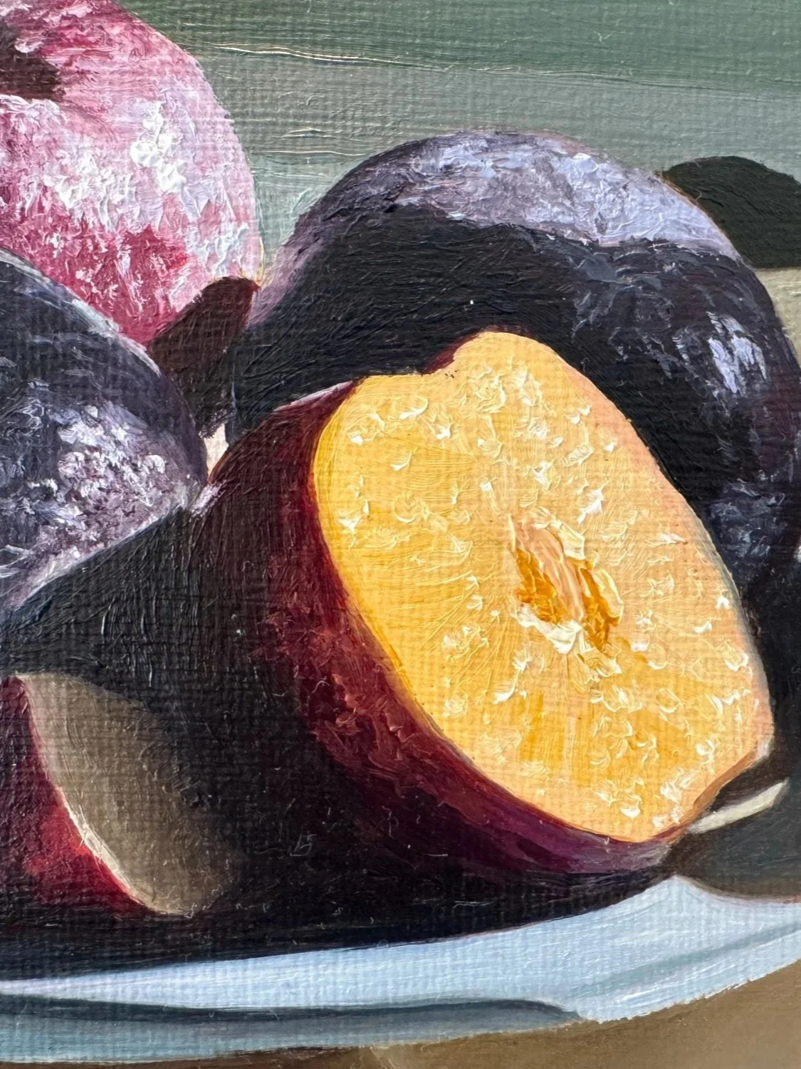 Close up of still life oil painting of plums showing brushwork and texture