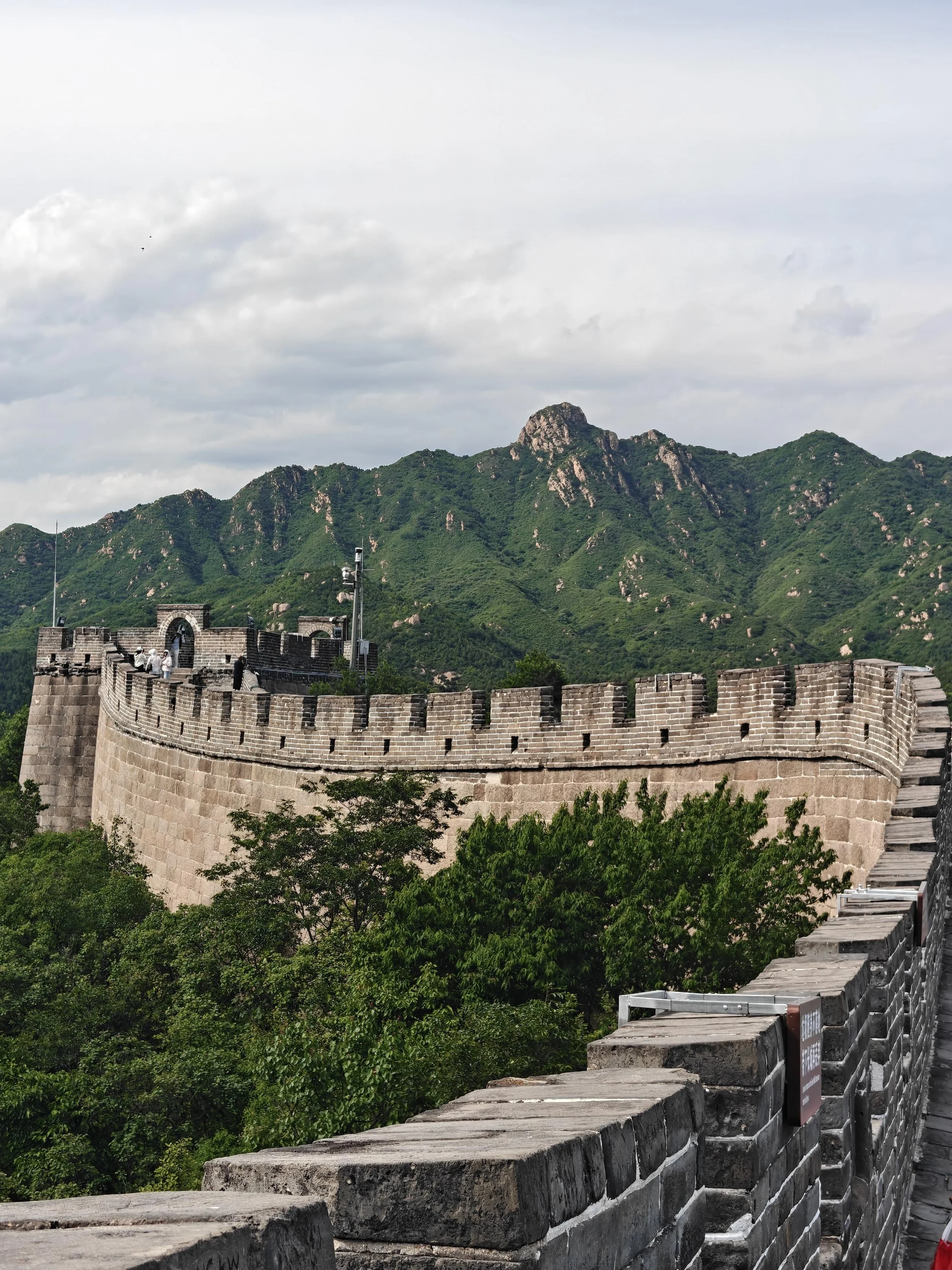 Mutianyu Great Wall winding along a forested ridge — watchtowers and 90% green cover