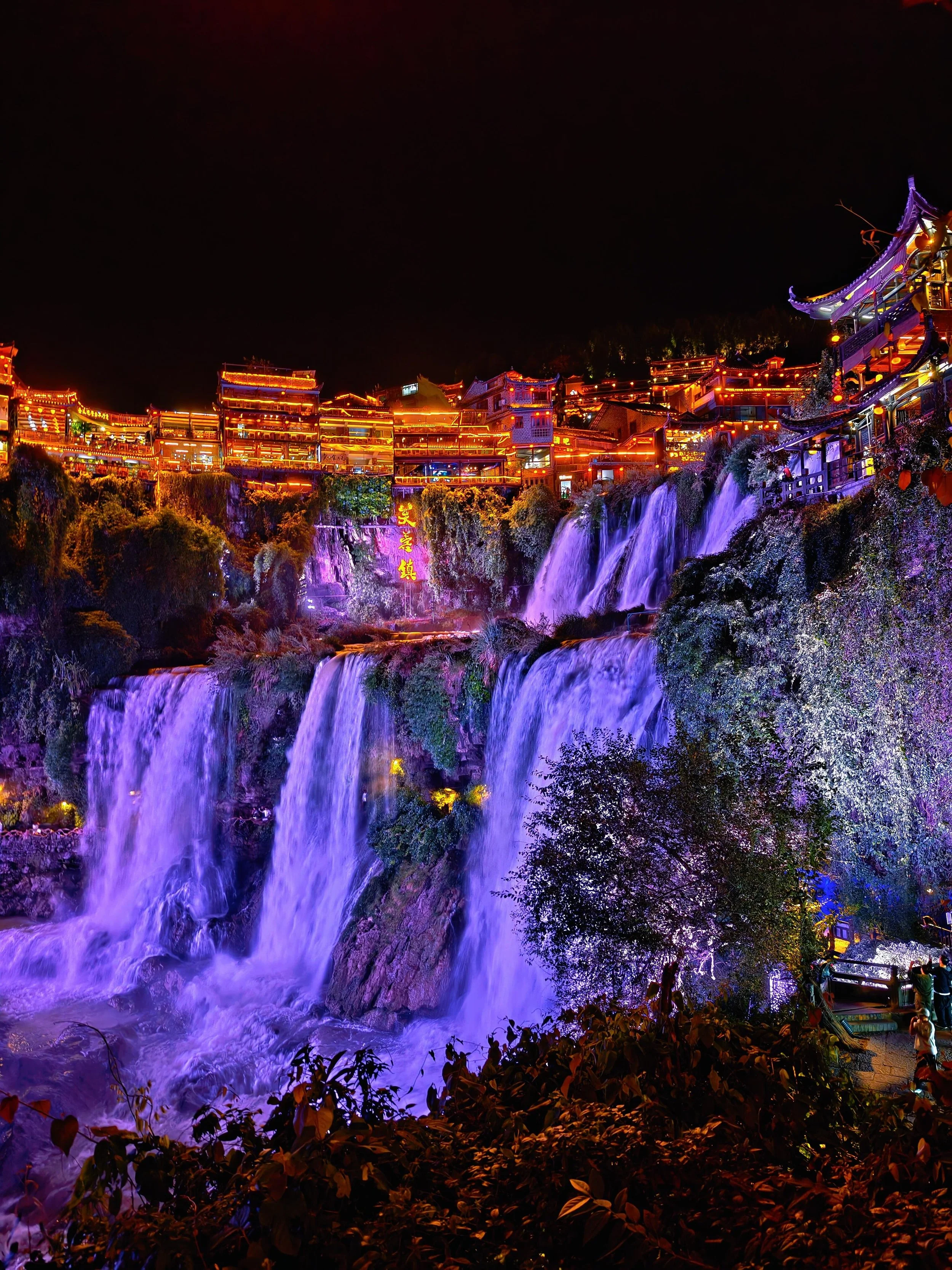 Furong Town after dark — the "hanging town on a waterfall" that comes alive at night