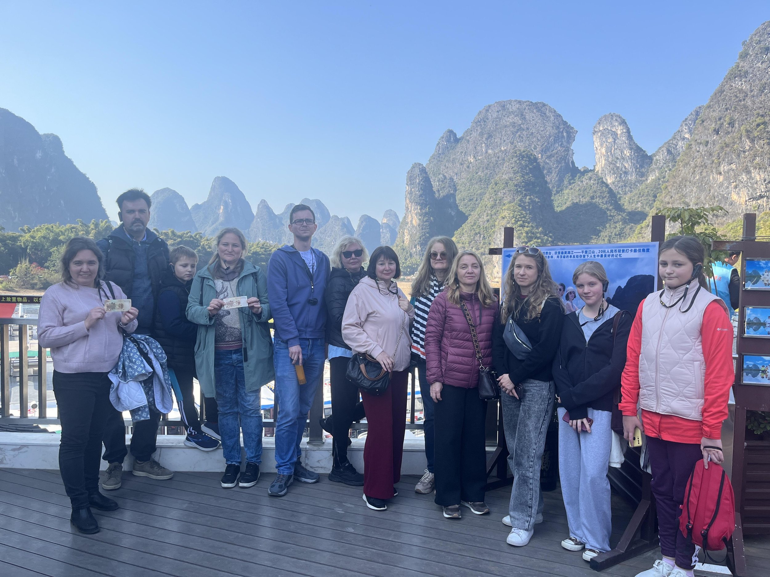 Employees of a Serbian insurance company and their families posing with the karst peaks of the Li River in Guilin during a private team-building tour