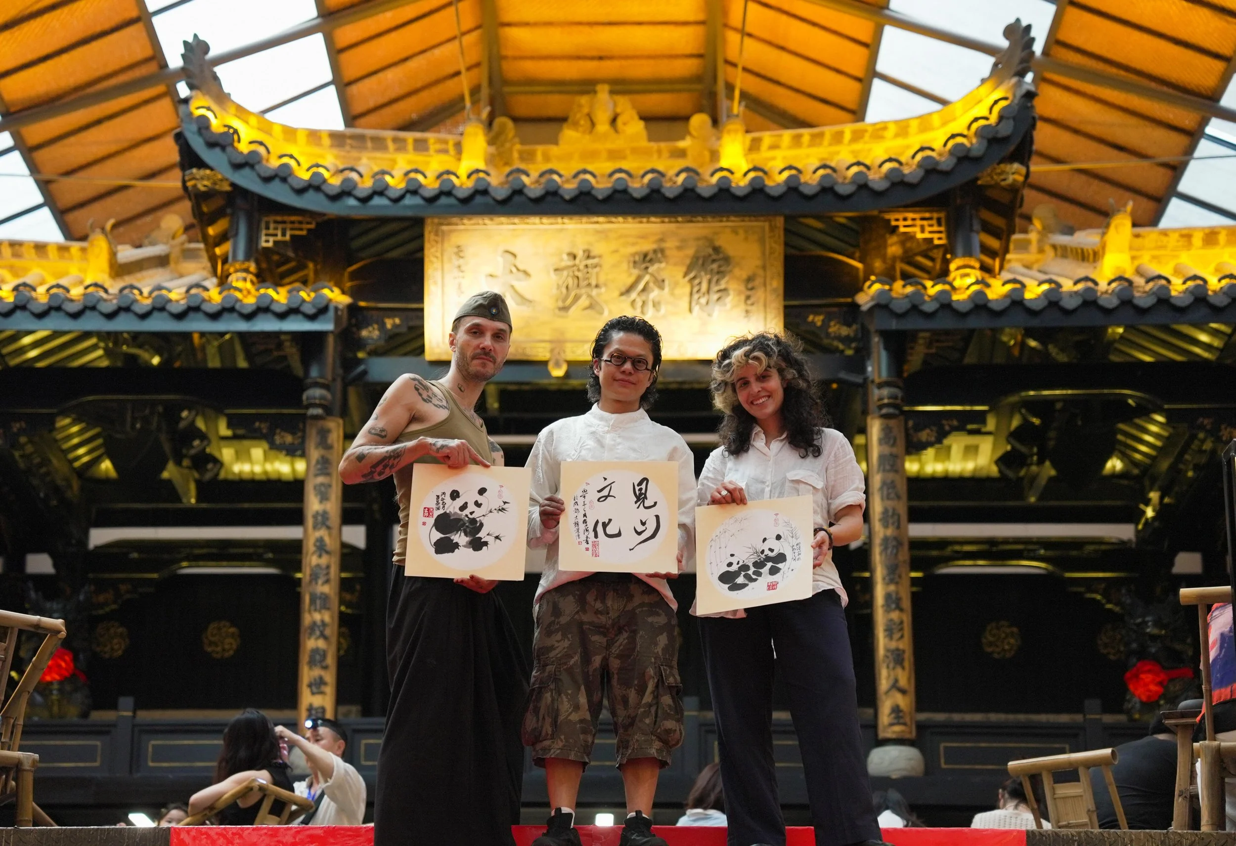 American artists exchanging ink calligraphy with local Chinese artists inside a traditional teahouse in Chengdu during a cultural exchange private tour