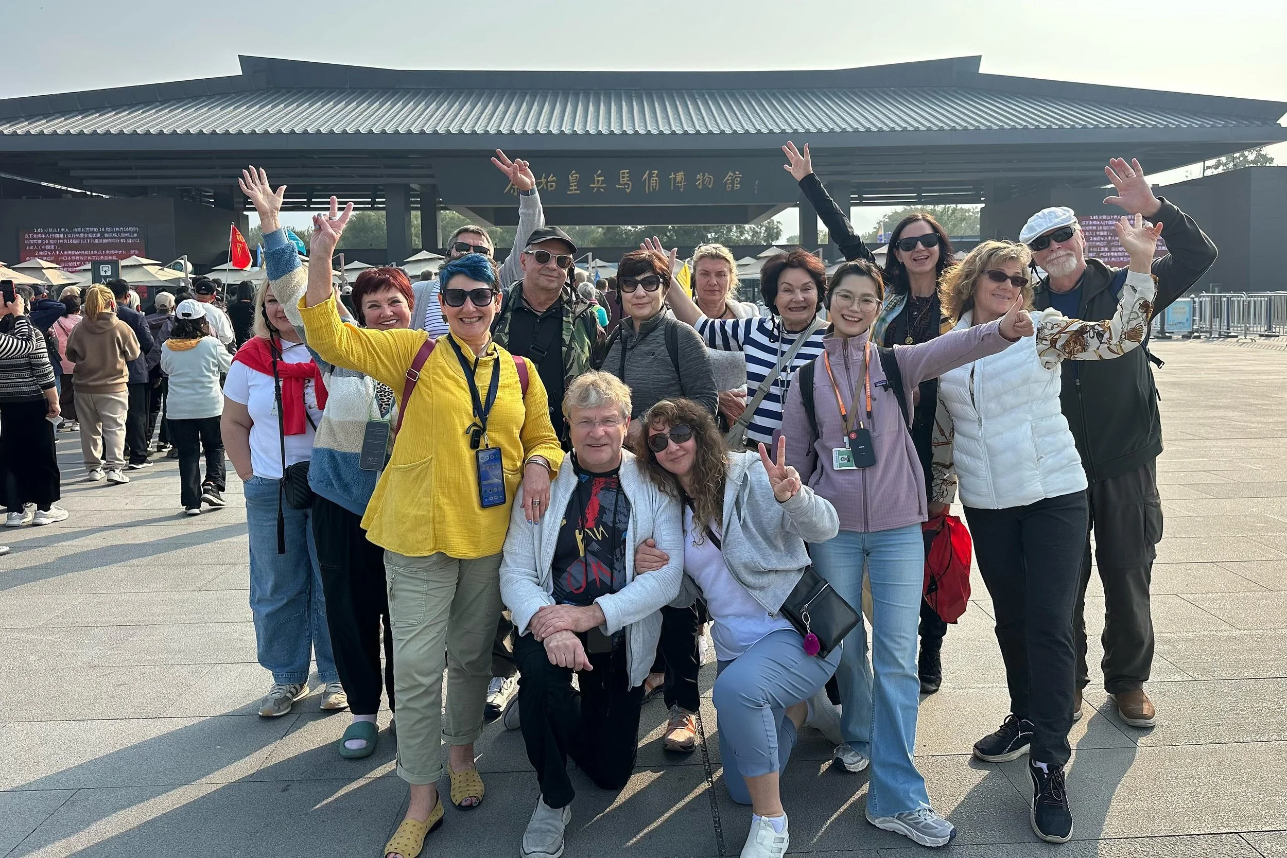 Group of employees from a Russian petroleum company posing in front of the Terracotta Warriors Museum in Xi'an during a private corporate tour