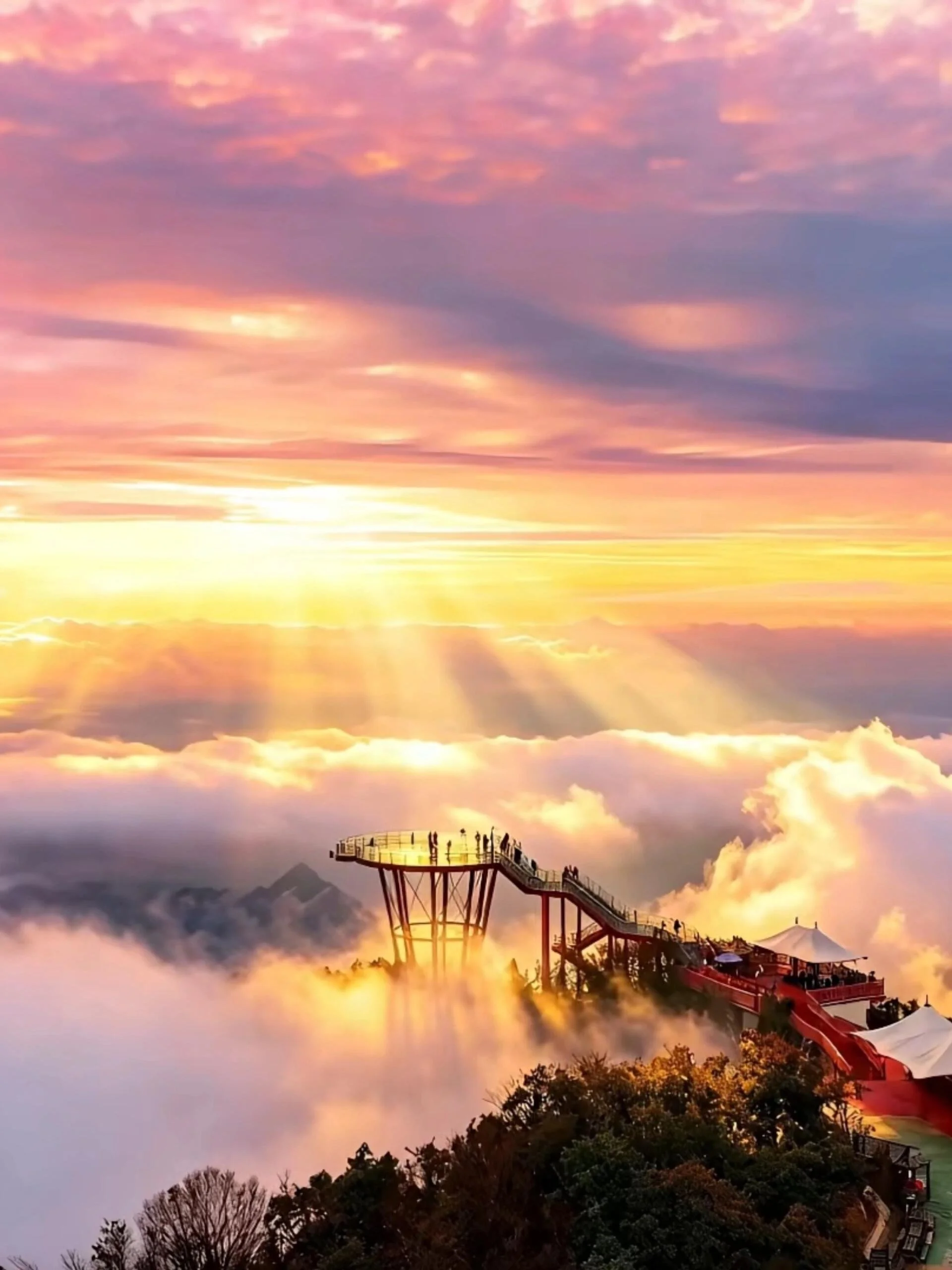 The 1520 Sky Eye glass observation platform at Qixing Mountain Zhangjiajie standing above a golden sea of clouds at sunset after rain