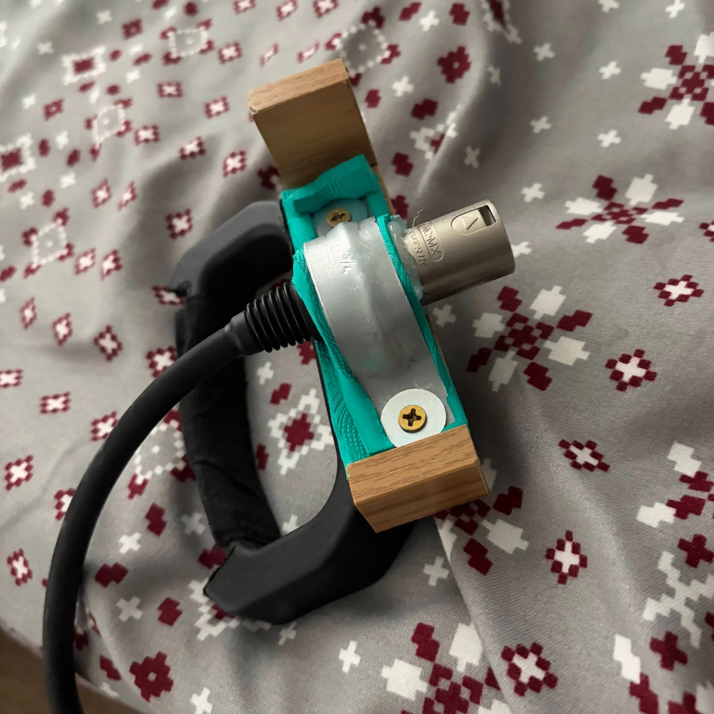 Grip adaptation for XLR wheelchair charger to assist with plugging it in