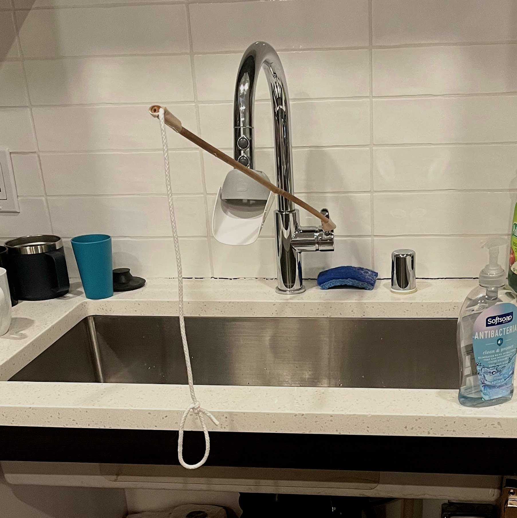 Faucet handle extender and flow adjuster for washing hands from a wheelchair