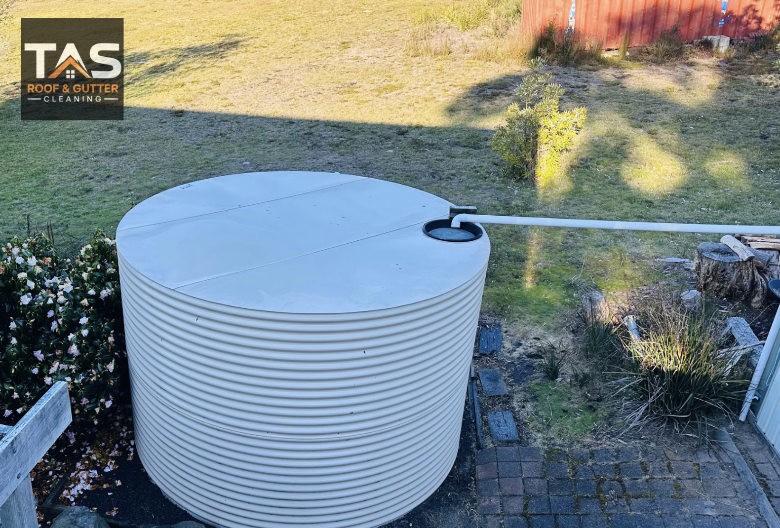 Poly rainwater tank with inlet pipe at a Tasmanian property, serviced by TAS Roof & Gutter Cleaning