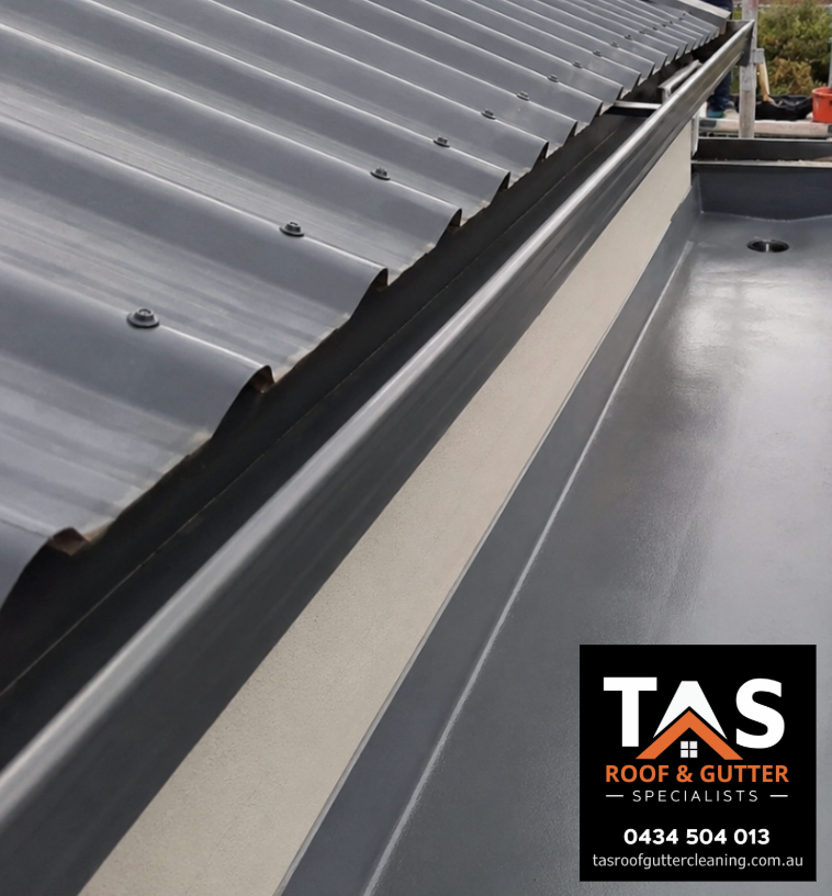 Clean internal box gutter and roof drainage outlet after professional gutter cleaning at a Hobart property.