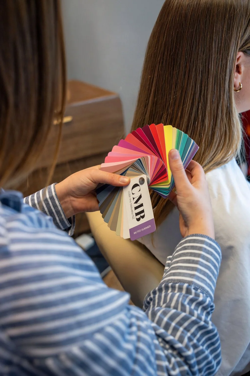 Personal colour consultation using seasonal colour swatches and palette analysis.