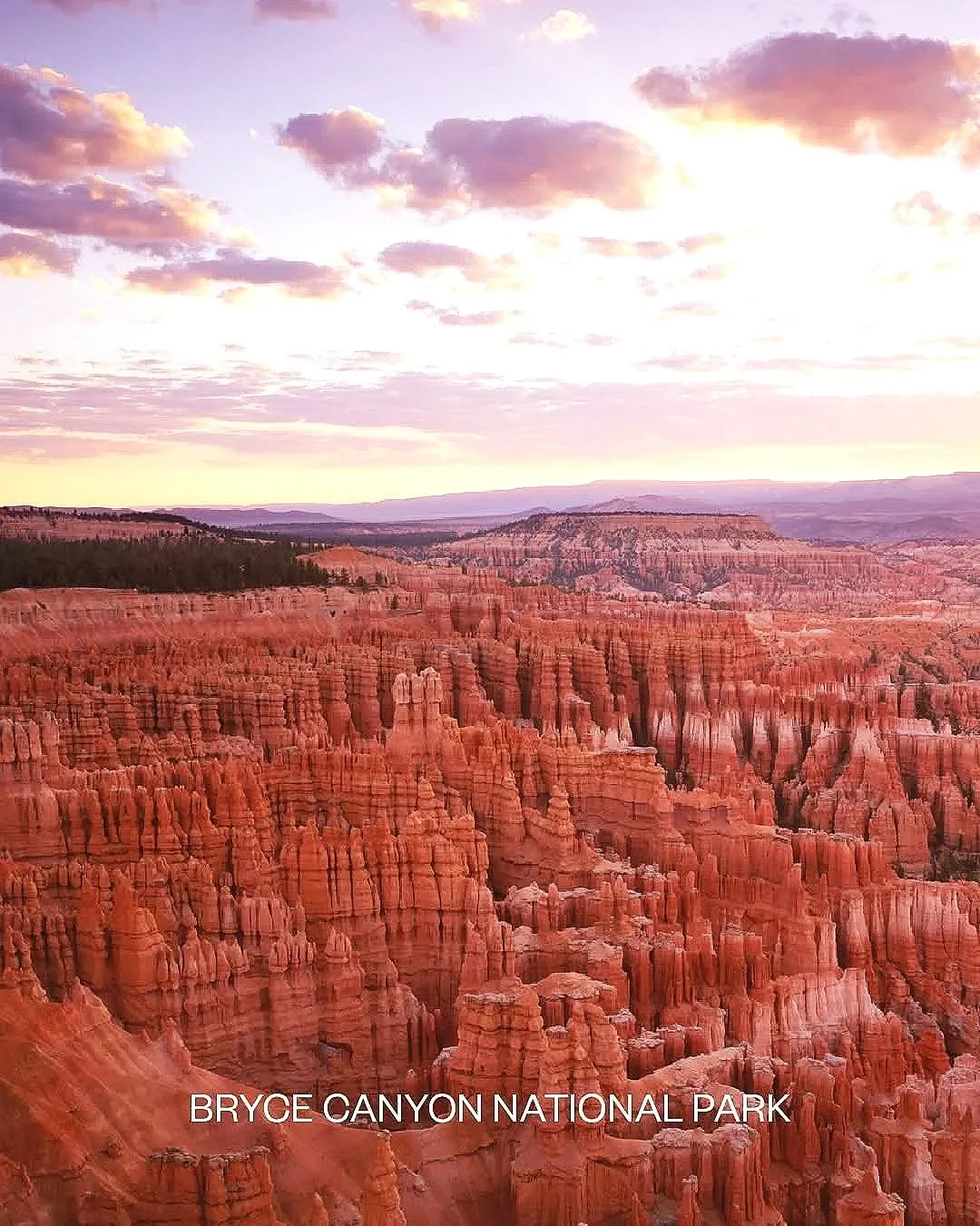 Sunset over Bryce Canyon National Park with orange hoodoo formations and a colorful sky with clouds.