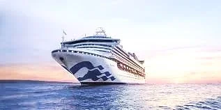 Large cruise ship sailing on calm water during sunset.