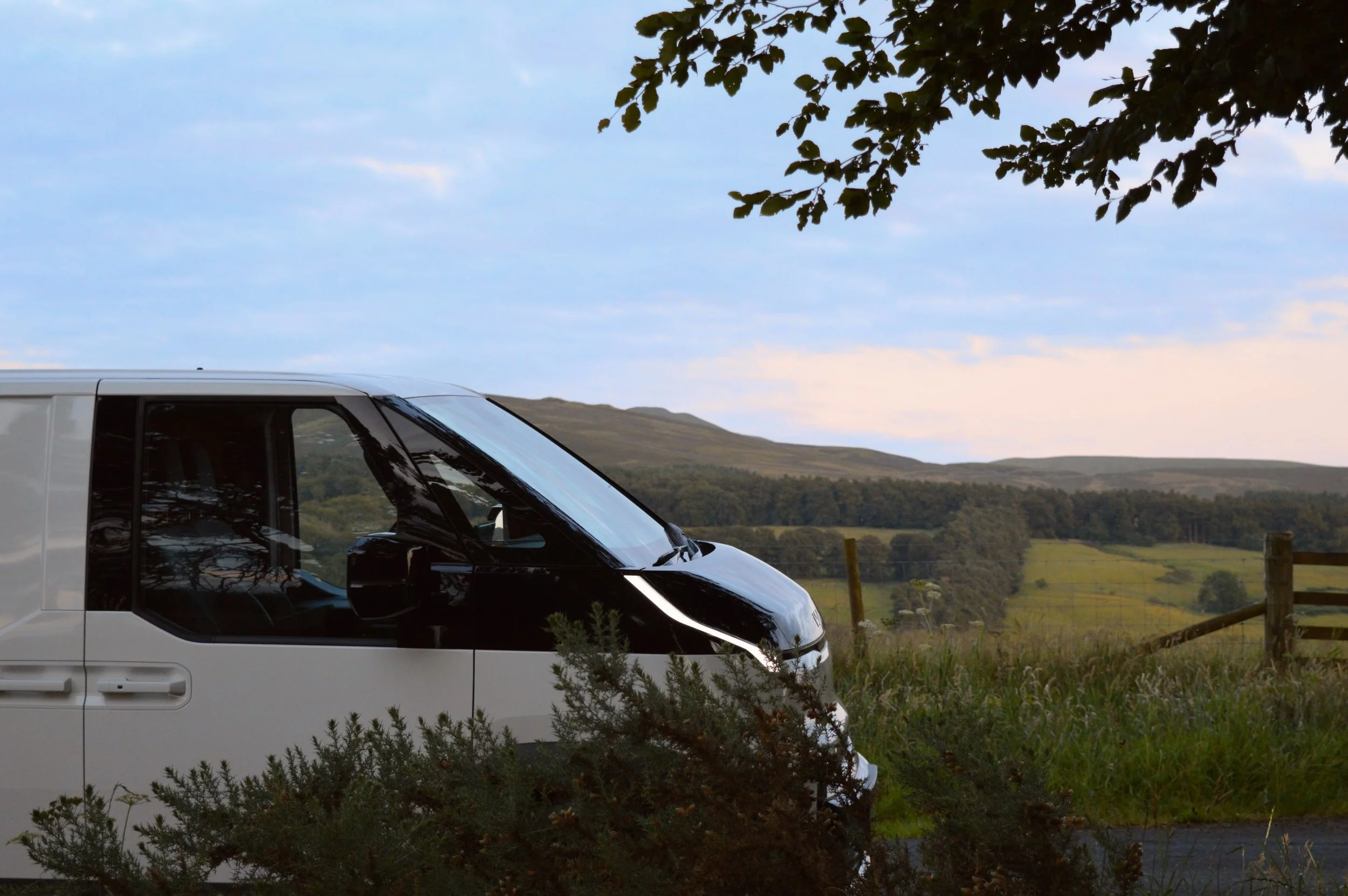 Ohm Campers Campervan side profile view with Edinburgh Pentland hills in the background.