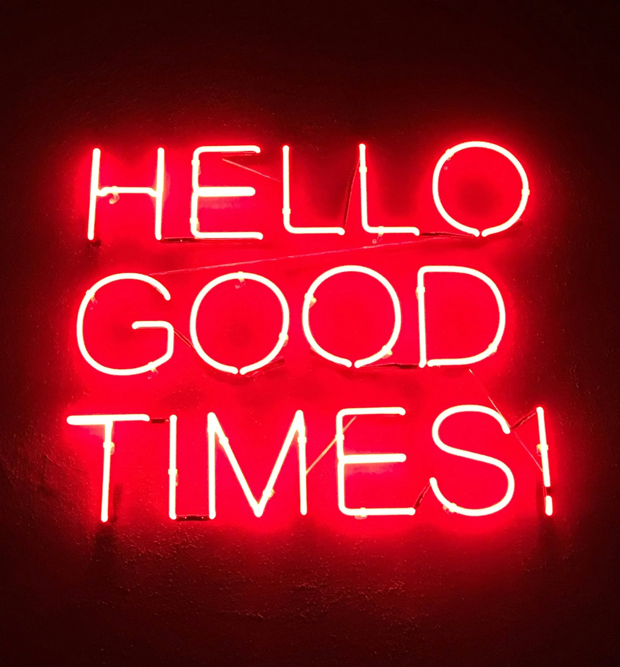 Hello Good Times red neon sign representing the nightlife energy at Whiskey & Ivory Prescott AZ