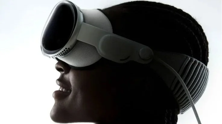 Person wearing a virtual reality headset, shown in profile with a smile.