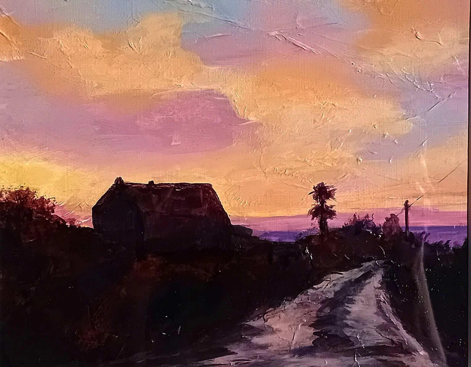 Acrylic painting of a rural landscape at sunset with a dark barn, a dirt road, and trees against a colorful sky with pink, purple, and orange clouds.