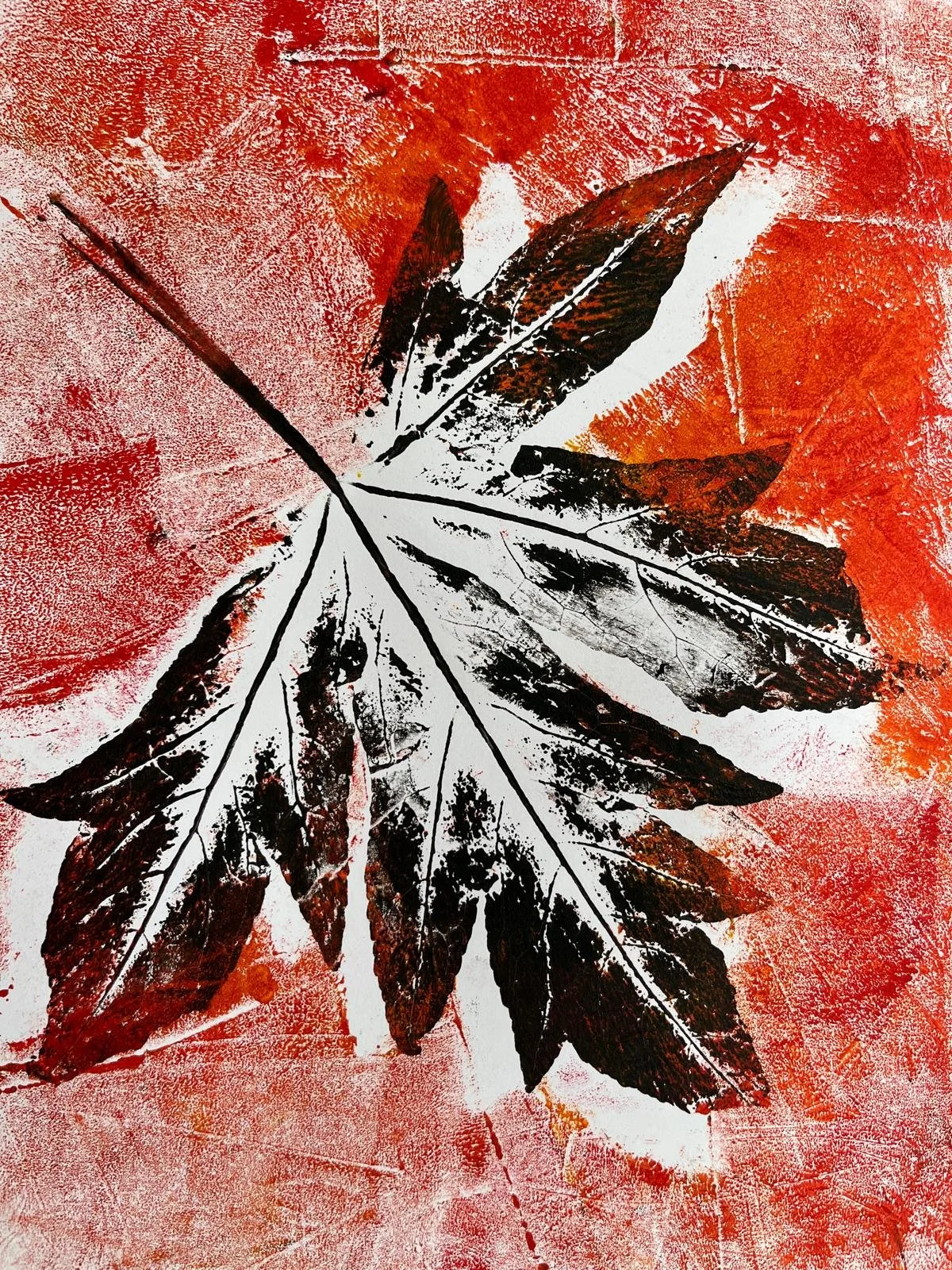 Abstract art of a leaf with black and white details on a red background.