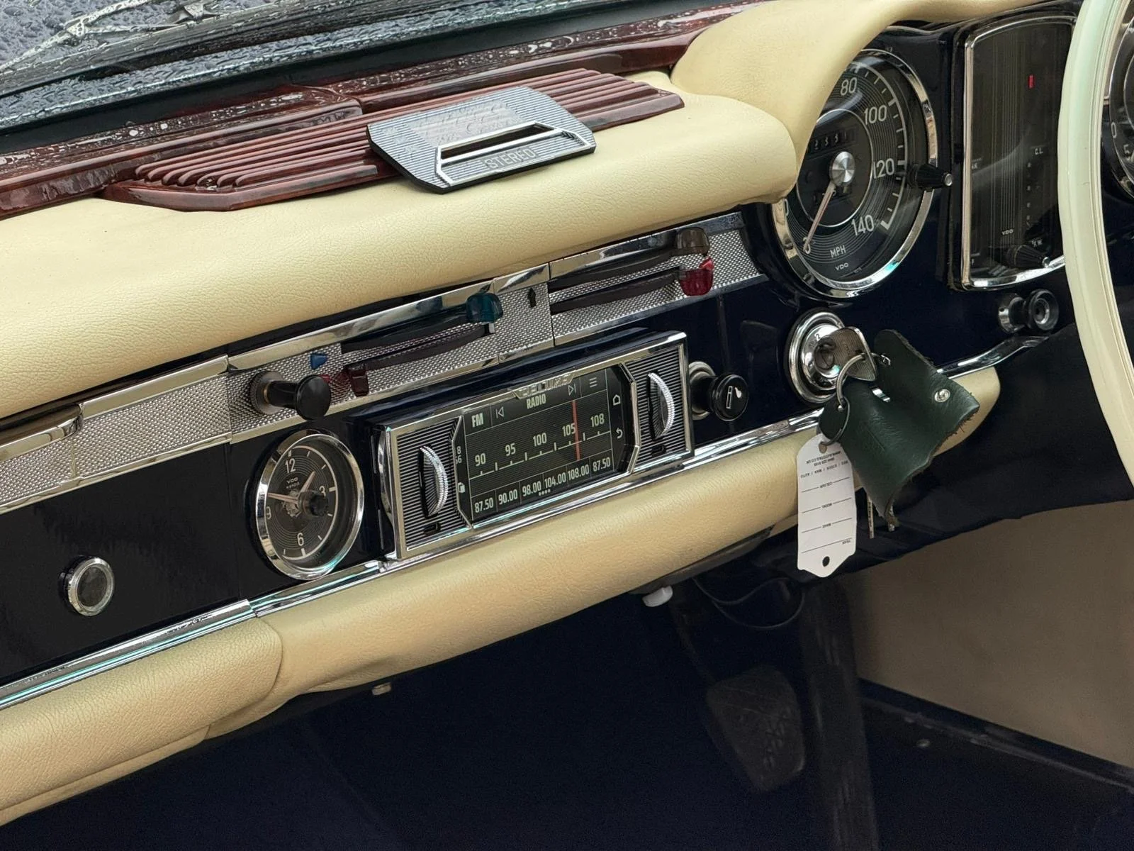 Close up of a MB W113 Pagoda, showing the Reluxe Stereo with DAB radio, blend in with surrounding metal toggle switch, and various control switches.