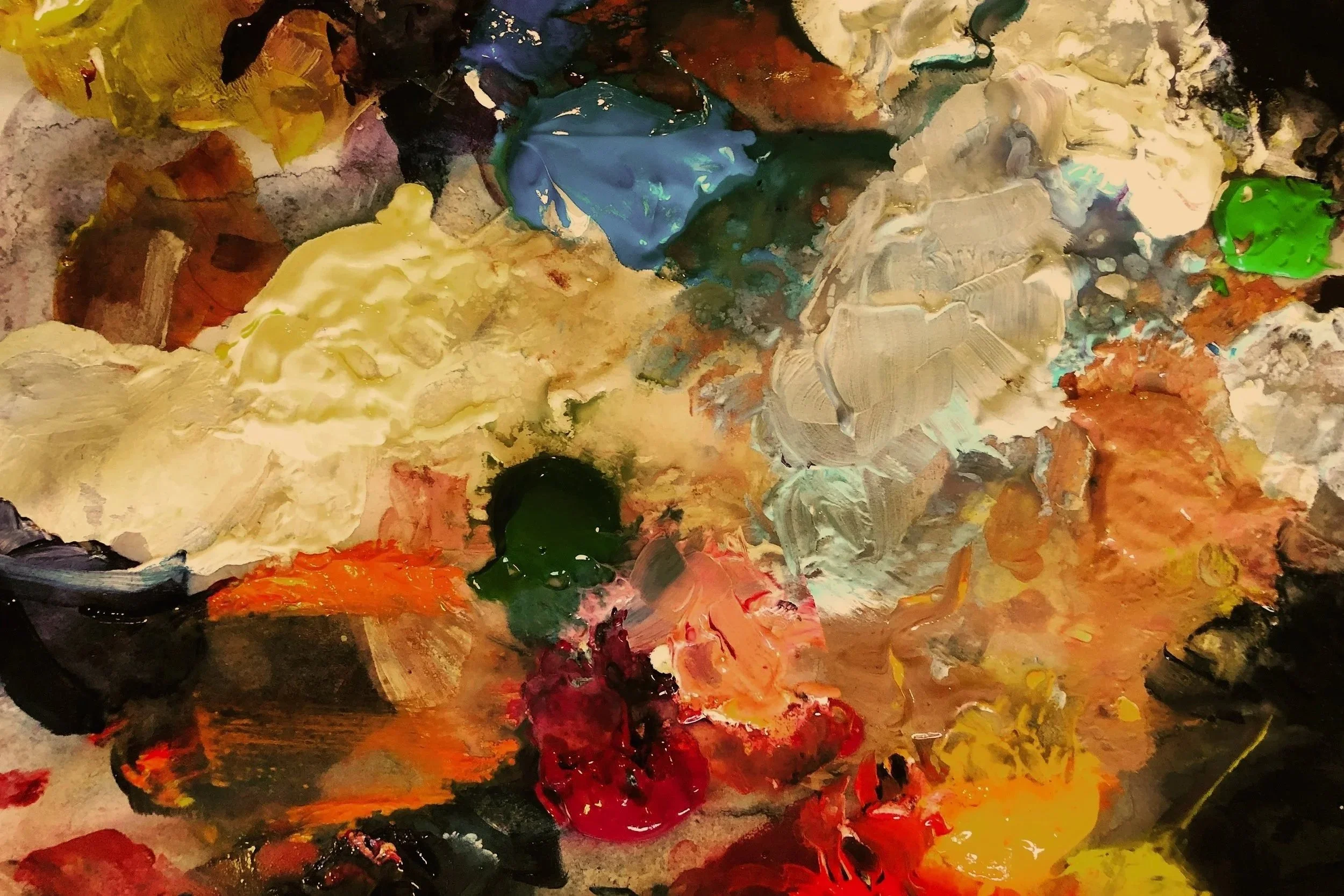 messy paint palette in artist's studio