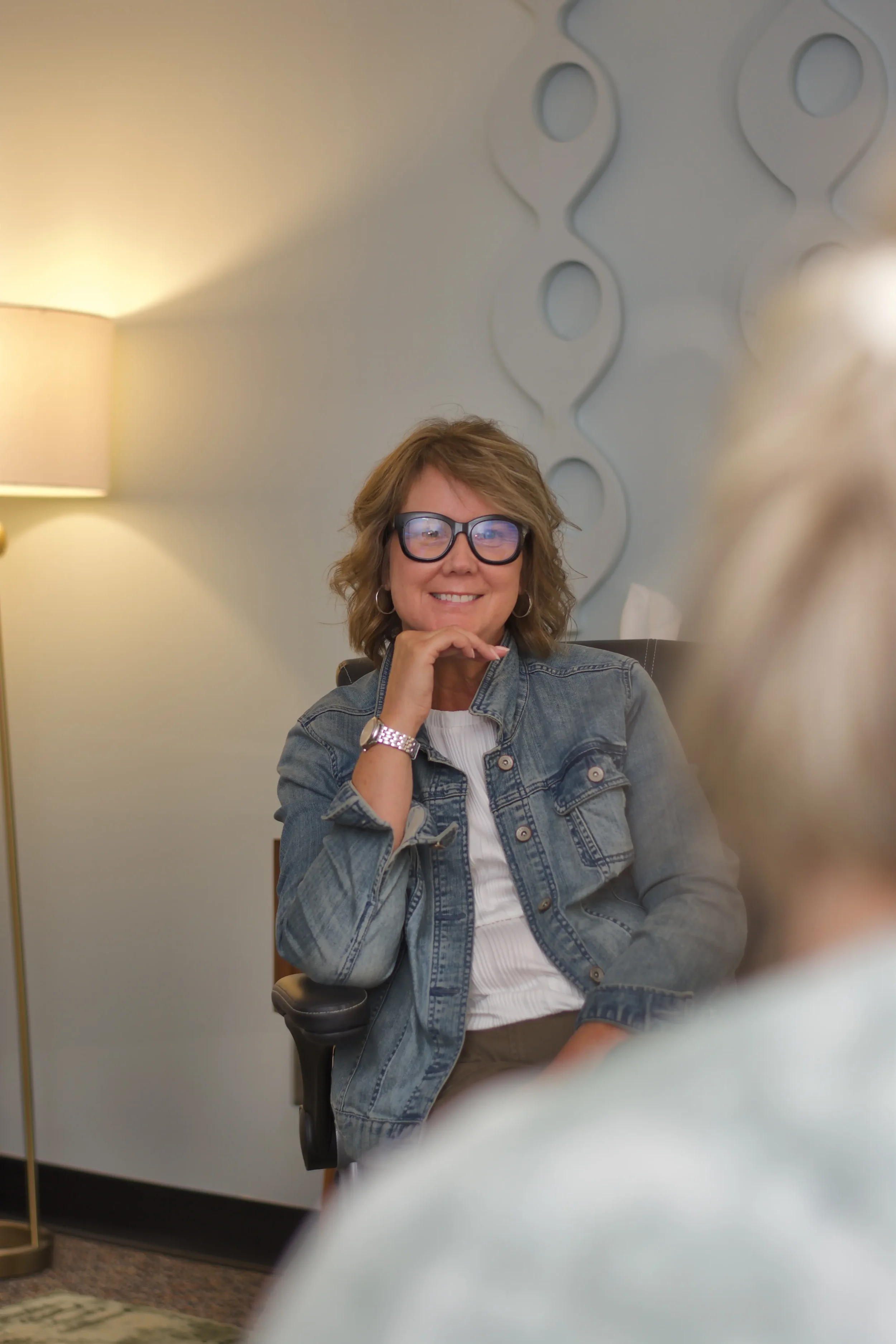 Kathie sitting with client