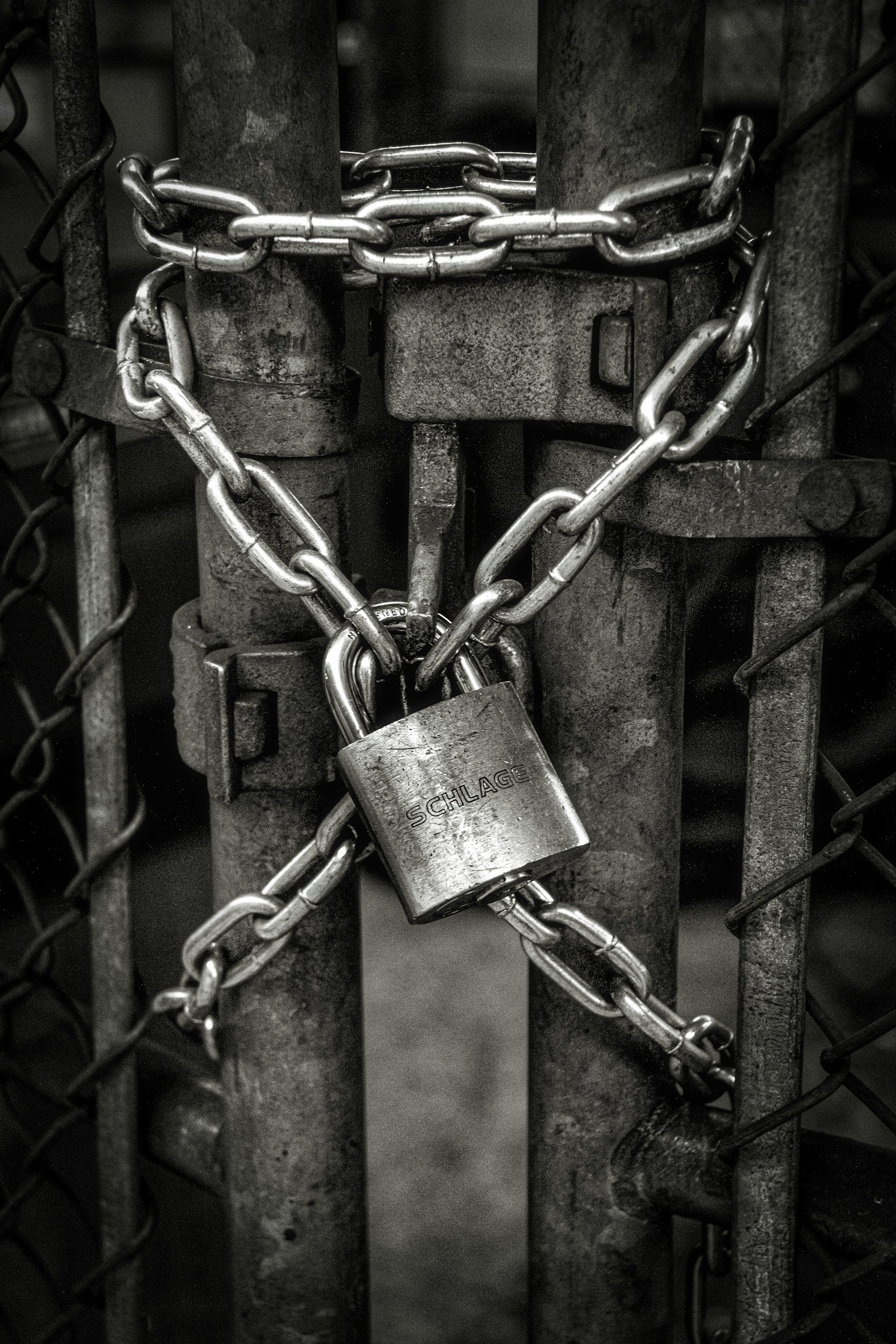A metal gate with a lock and chain securing it.