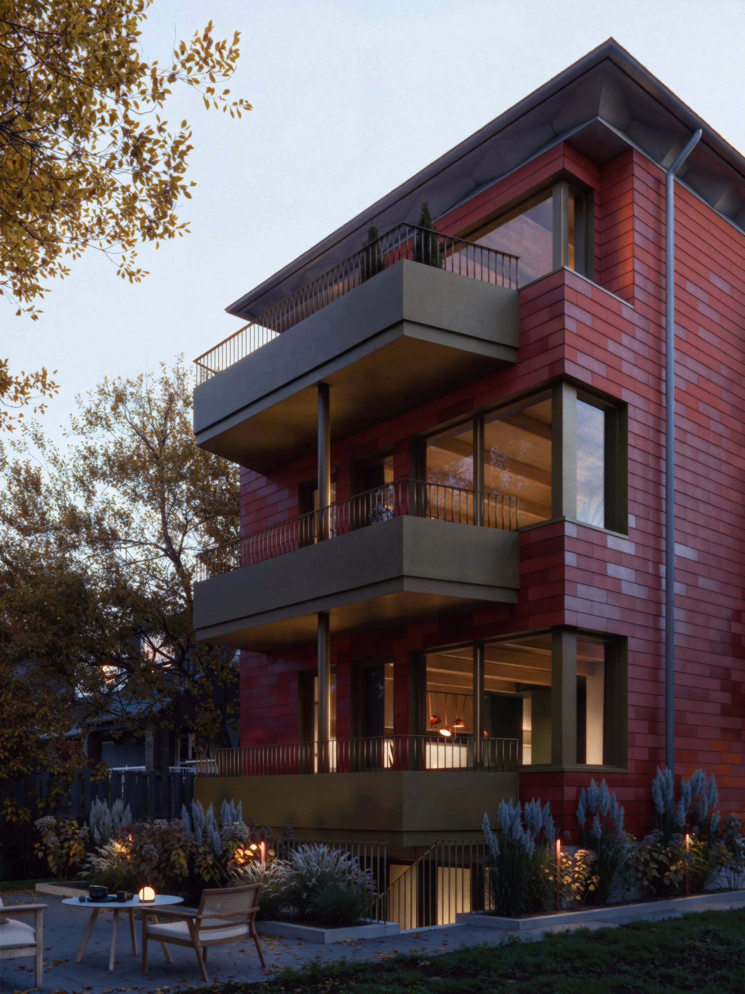 A modern, multi-story residential building with a terracotta colored shingles and concrete exterior, featuring large windows and balconies, illuminated with warm interior lighting, surrounded by trees and a landscaped garden with outdoor seating.