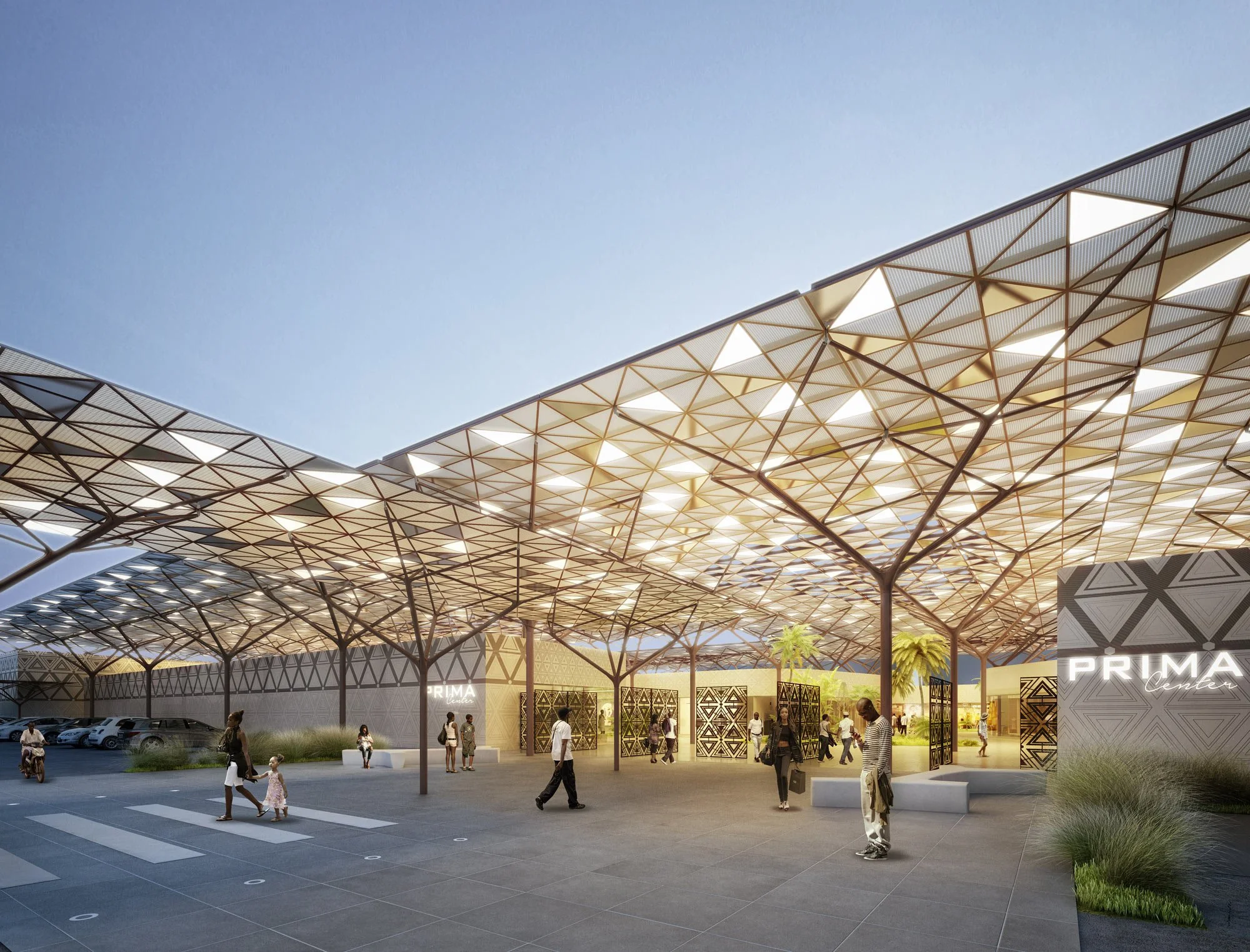 Une vue d'un centre commercial avec un toit architecturé en formes géométriques, des personnes marchant, et une signalisation lumineuse indiquant 'PRIMA Center'.