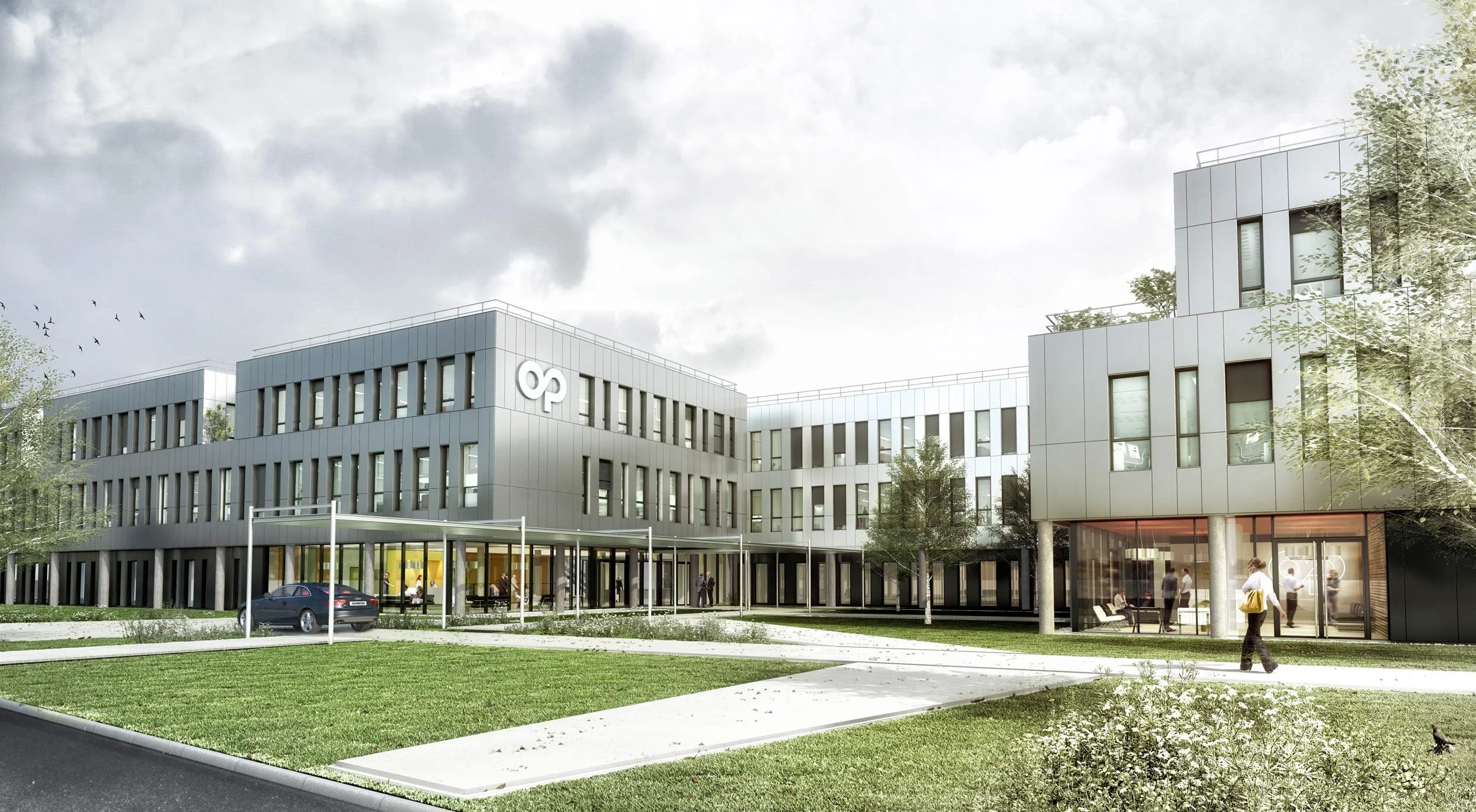 Bâtiment moderne avec plusieurs étages, entouré d'arbres et d'une pelouse, avec des personnes entrant et sortant, et une voiture garée devant.