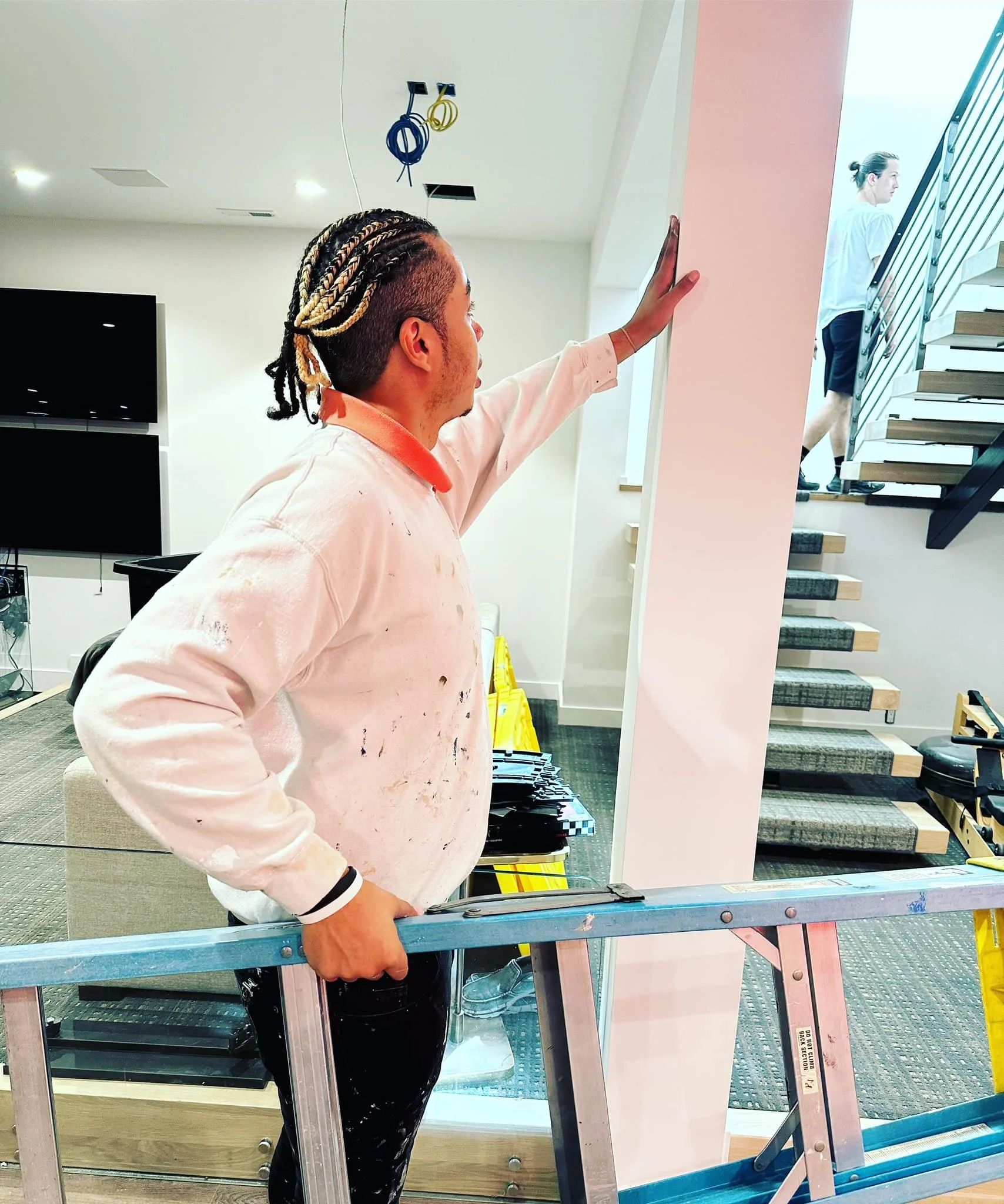 Pastel Painter, owner & operator carrying a ladder