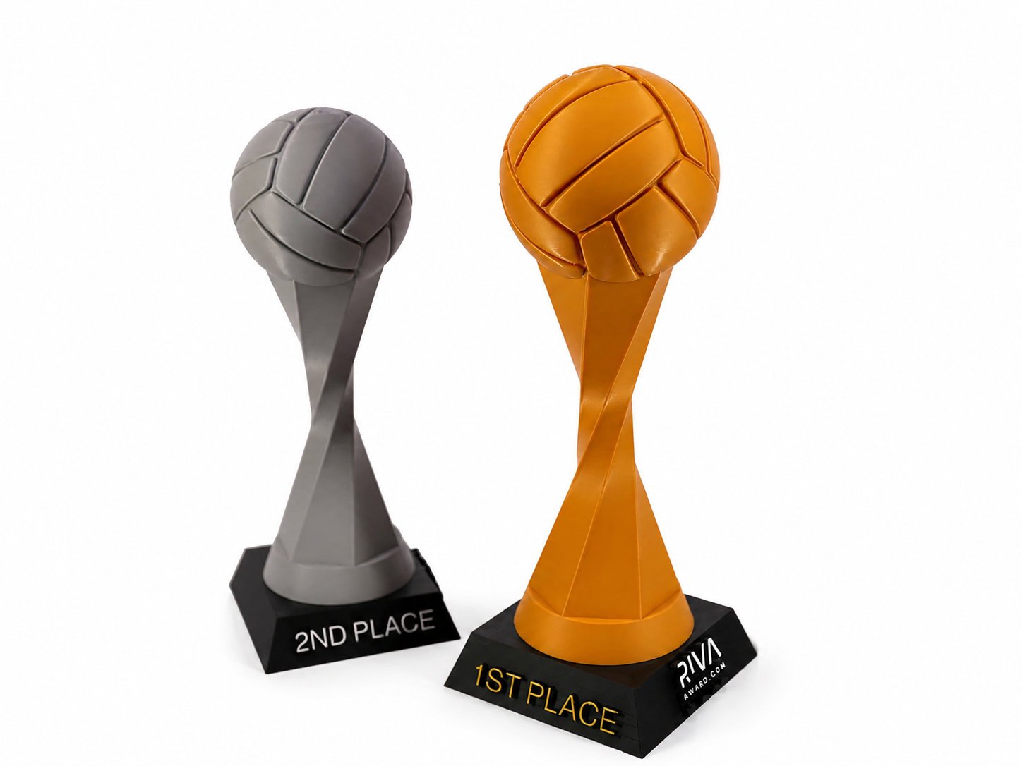 Trophies in the shape of volleyballs, with one silver for second place and one gold for first place, displayed on black bases labeled '2ND PLACE' and '1ST PLACE'.