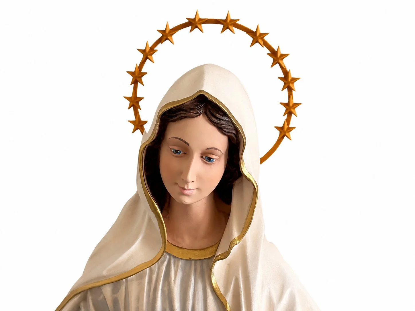 Statue of the Virgin Mary with a white robe and a gold-trimmed hood, wearing a halo of golden stars.