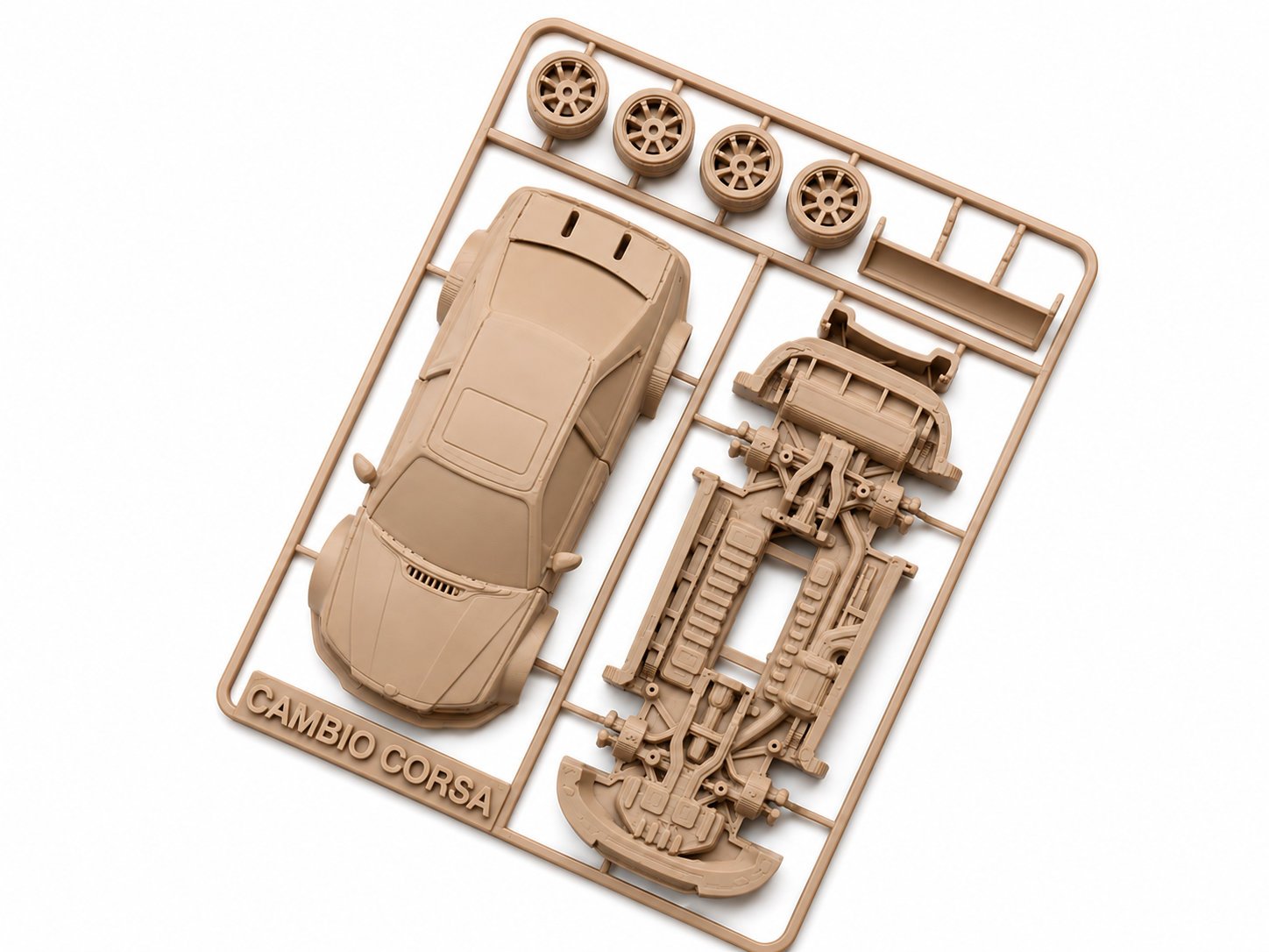 Unassembled beige plastic model kit of a car, labeled 'Cambio Corsa,' with car body, wheels, and engine parts on a plastic frame.